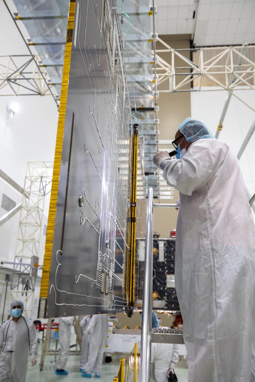 Team members begin to retract the second of two solar arrays attached to NASA’s Psyche spacecraft inside the Astrotech Space Operations Facility near the agency’s Kennedy Space Center in Florida on July 25, 2023. The solar arrays, which were shipped from Maxar Technologies, in San Jose, California, are being stowed for launch. They are part of the solar electric propulsion system, provided by Maxar, that will power the spacecraft on its journey to explore a metal-rich asteroid. Psyche will launch atop a SpaceX Falcon Heavy rocket from Launch Complex 39A at Kennedy. Launch is targeted for Oct. 5, 2023. Riding with Psyche is a pioneering technology demonstration, NASA’s Deep Space Optical Communications (DSOC) experiment.
