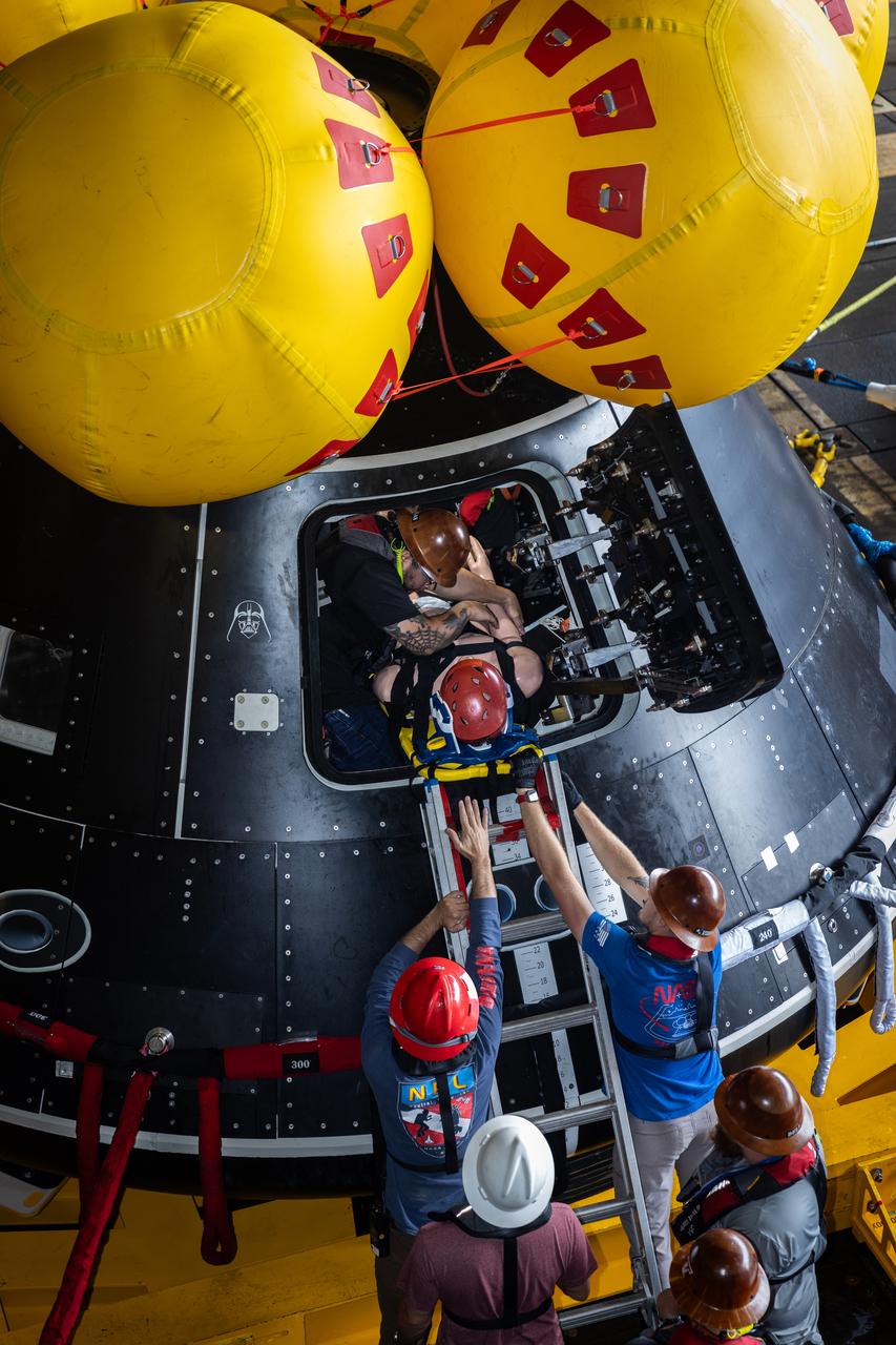 Members of NASA’s Landing and Recovery team load a mannequin into the Crew Module Test Article (CMTA) during Underway Recovery Test 10 in the Pacific Ocean. The CMTA is a is a full-scale mockup of the Orion spacecraft and is used by NASA and its Department of Defense partners to practice recovery procedures for crewed Artemis missions. The team uses the mannequin to practice recovering astronauts out of the capsule and safely getting them to the recovery vessel nearby. 