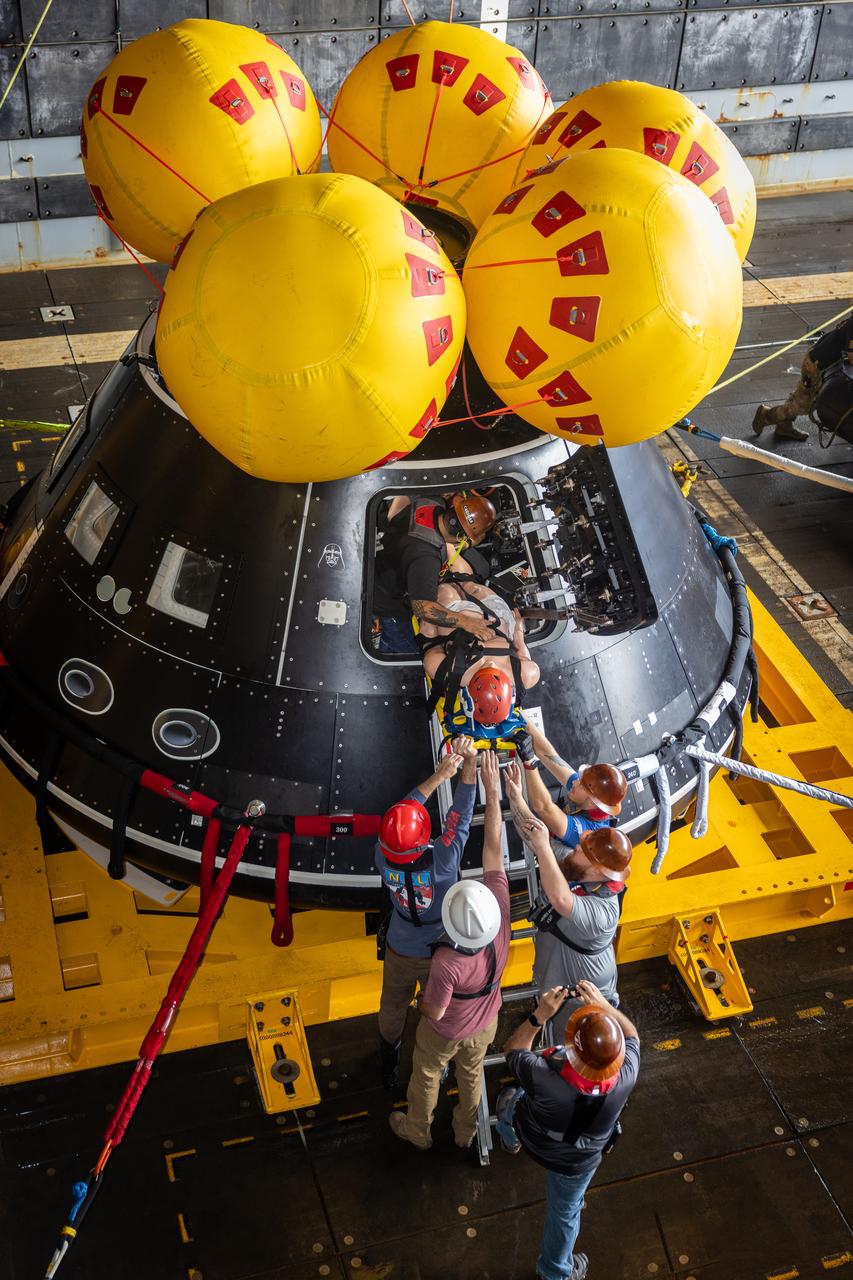 Members of NASA’s Landing and Recovery team load a mannequin into the Crew Module Test Article (CMTA) during Underway Recovery Test 10 in the Pacific Ocean. The CMTA is a is a full-scale mockup of the Orion spacecraft and is used by NASA and its Department of Defense partners to practice recovery procedures for crewed Artemis missions. The team uses the mannequin to practice recovering astronauts out of the capsule and safely getting them to the recovery vessel nearby. 