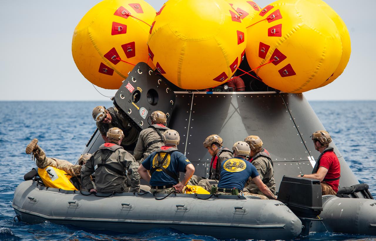 NASA, Navy, and Air Force personnel practice Artemis recovery procedures in the Pacific Ocean as part of Underway Recovery Test-10 off the coast of San Diego. In this photo Navy divers are seen entering the Orion Crew Module Test Article to prepare to practice recovering astronauts out of the spacecraft and onto an inflatable “front porch” where the crew will be picked up with helicopters and lifted up via helicopter back to the recovery vessel.