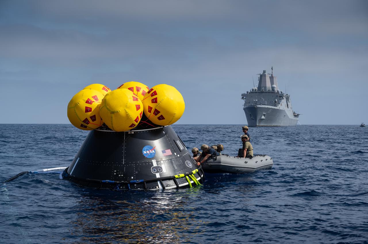 The Crew Module Test Article (CMTA) is seen in the waters of the Pacific Ocean during NASA’s Underway Recovery Test 10 (URT-10). The CMTA is a full-scale mockup of the Orion Spacecraft and is used by NASA and its Department of Defense partners to practice recovery procedures for crewed Artemis missions. URT-10 is the first test specifically in support of the Artemis II mission and allowed the team to practice what it will be like to recover astronauts and get them back to the recovery ship safely. In this photo Navy divers from Explosive Ordnance Disposal (EOD) Expeditionary Support Unit 1 secure the CMTA and prepare it to be recovered back inside USS John P Murtha.