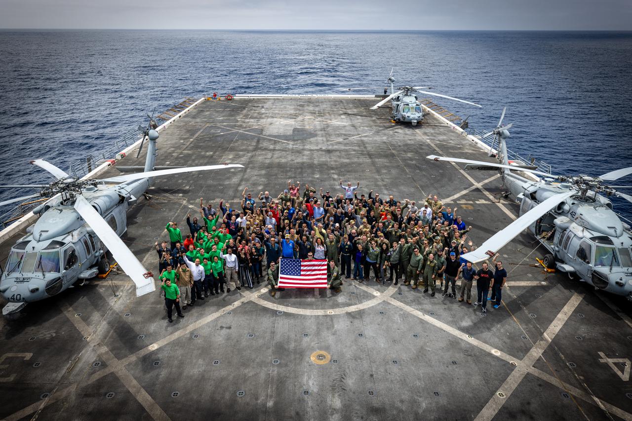 Members of NASA’s Landing and Recovery team and partners from the Department of Defense stand on the flight deck of USS John P. Murtha during Underway Recovery Test 10 (URT-10) off the coast of San Diego. URT-10 is the tenth in a series of Artemis recovery tests, but the first time NASA and its partners from the Department of Defense put their Artemis II recovery procedures to the test.