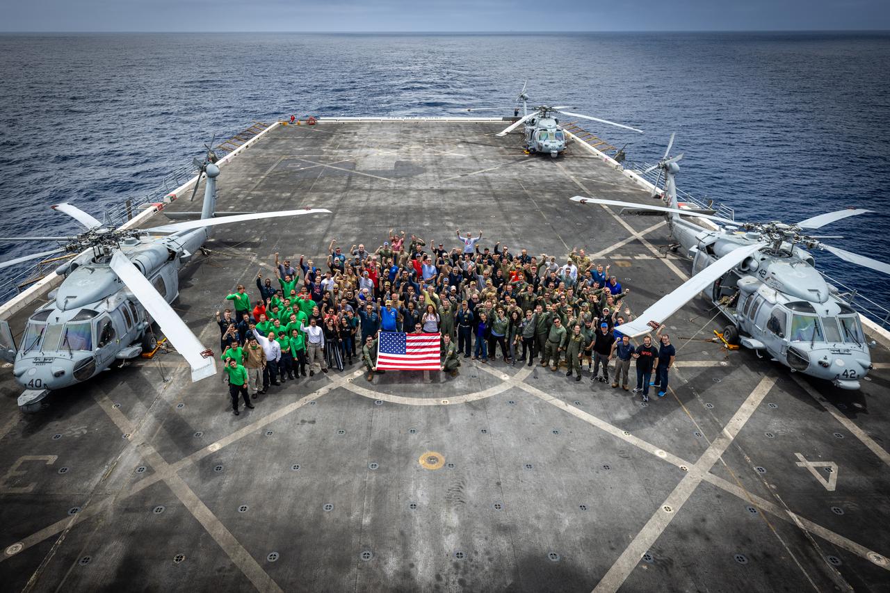 Members of NASA’s Landing and Recovery team and partners from the Department of Defense stand on the flight deck of USS John P. Murtha during Underway Recovery Test 10 (URT-10) off the coast of San Diego. URT-10 is the tenth in a series of Artemis recovery tests, but the first time NASA and its partners from the Department of Defense put their Artemis II recovery procedures to the test.