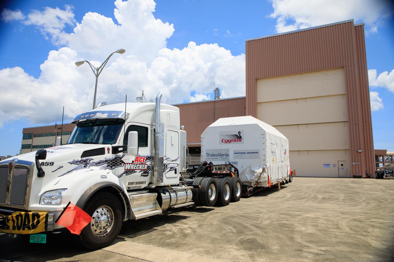The Northrop Grumman Cygnus spacecraft's pressurized cargo module (PCM) arrives at the Space Station Processing Facility of NASA's Kennedy Space Center in Florida on Aug. 2, 2023. The PCM is sealed in an environmentally controlled shipping container, pulled in by truck on a flatbed trailer. Cygnus will launch later this year atop a SpaceX Falcon 9 rocket from Cape Canaveral Space Force Station’s Space Launch Complex 40 to the International Space Station. Cygnus will undergo prelaunch processing at Kennedy before it is transported to SpaceX’s integration facility.
