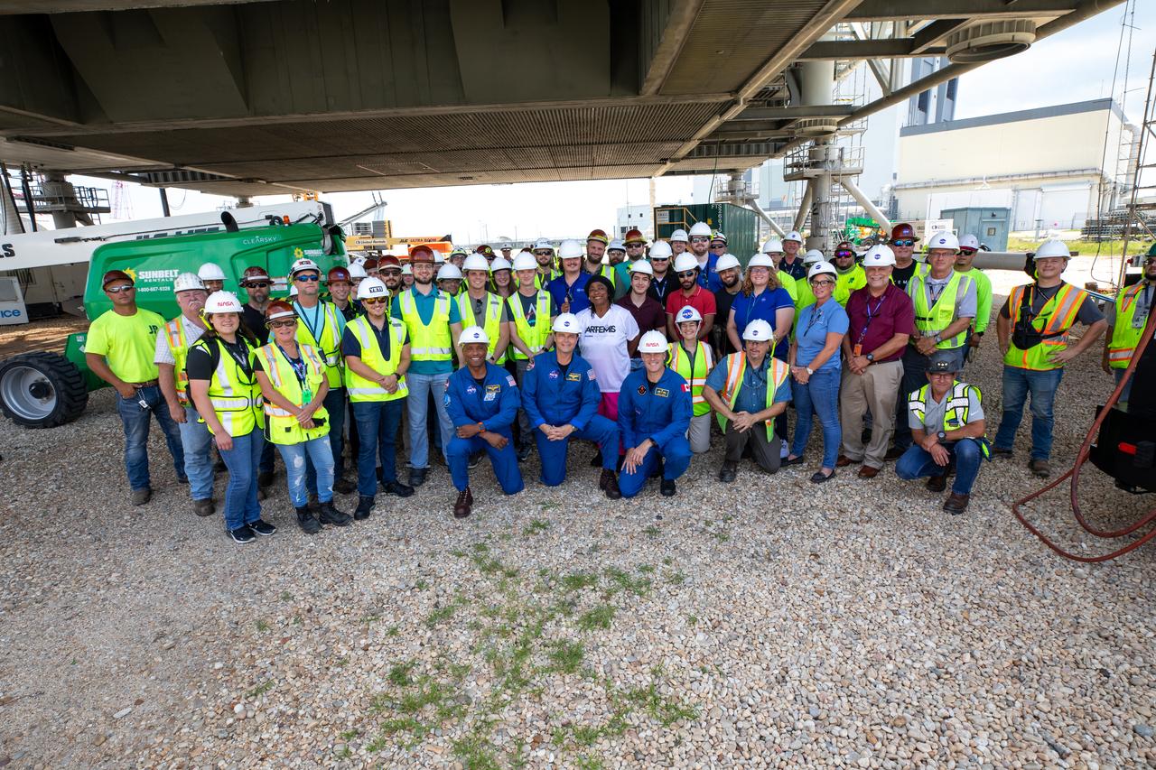 Artemis II astronauts visit NASA’s Kennedy Space Center in Florida on Aug. 7, 2023. In front, from left, are NASA astronauts Victor Glover and Reid Wiseman, and CSA (Canadian Space Agency) astronaut Jeremy Hansen with the Exploration Ground Systems team beneath the mobile launcher 1. The approximately 10-day Artemis II flight will test NASA’s foundational human deep space exploration capabilities, the Space Launch System rocket and Orion spacecraft, for the first time with astronauts and will pave the way for lunar surface missions, including landing the first woman and the first person of color on the Moon. 