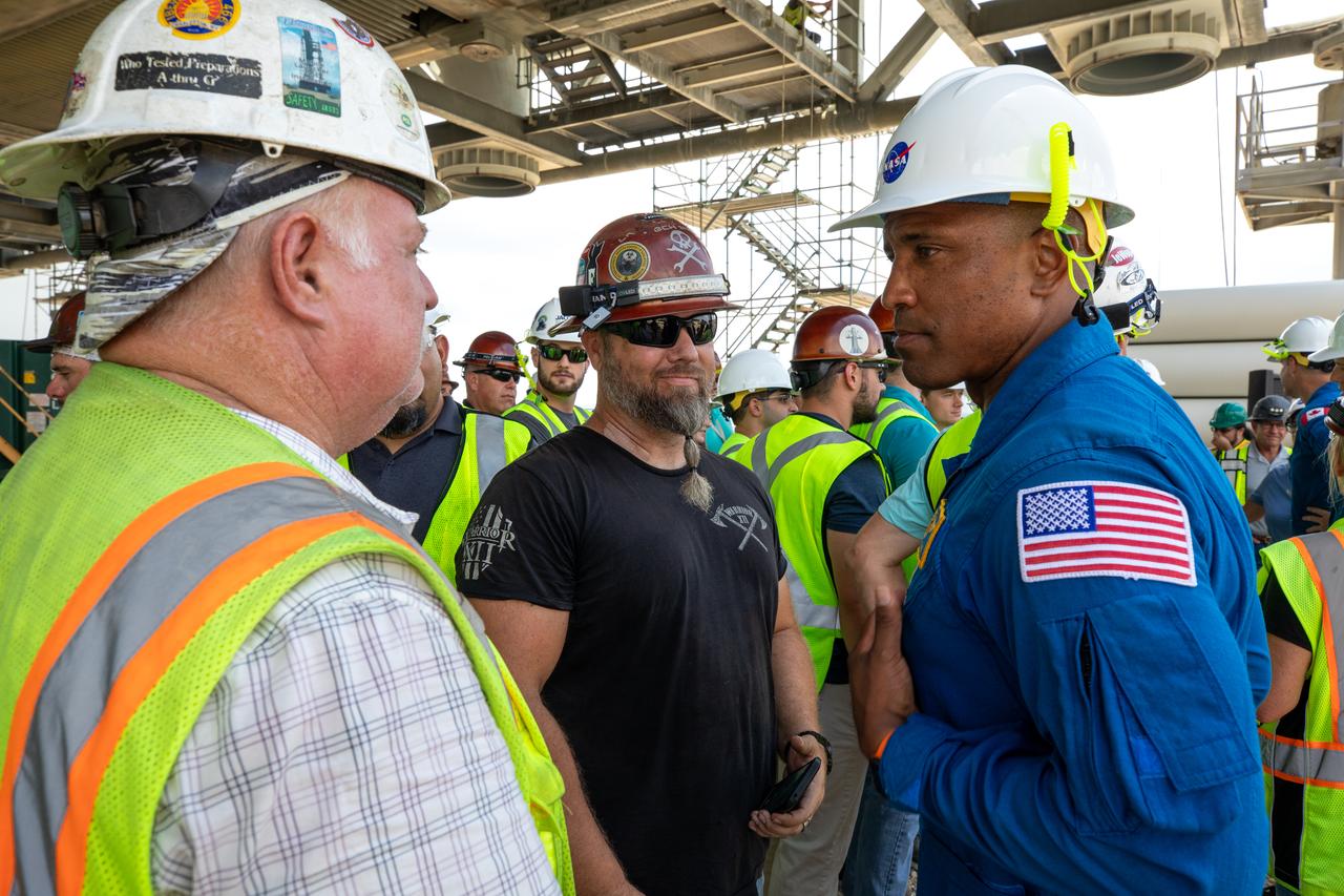 Artemis II NASA astronaut Victor Glover is seen with Exploration Ground Systems workers during a visit to the agency’s Kennedy Space Center in Florida on Aug. 7, 2023. The approximately 10-day Artemis II flight will test NASA’s foundational human deep space exploration capabilities, the Space Launch System rocket and Orion spacecraft, for the first time with astronauts and will pave the way for lunar surface missions, including landing the first woman and the first person of color on the Moon. 
