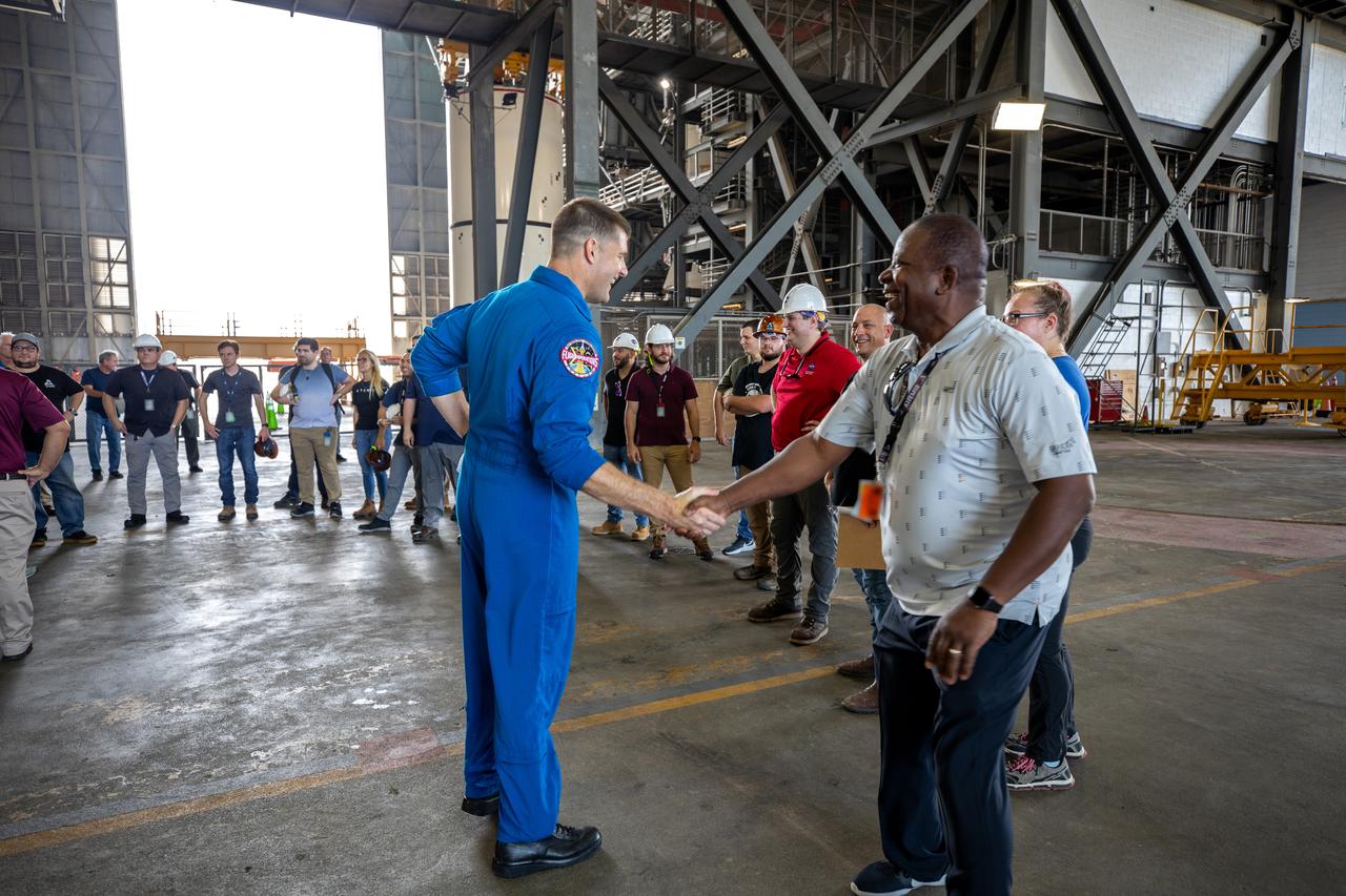 Jeremy Hansen, at left, CSA (Canadian Space Agency) Artemis II astronaut, greets members of the Exploration Ground Systems team inside the transfer aisle of the Vehicle Assembly Building during a visit at NASA’s Kennedy Space Center in Florida on Aug. 7, 2023.  The approximately 10-day Artemis II flight will test NASA’s foundational human deep space exploration capabilities, the Space Launch System rocket and Orion spacecraft, for the first time with astronauts and will pave the way for lunar surface missions, including landing the first woman and the first person of color on the Moon.