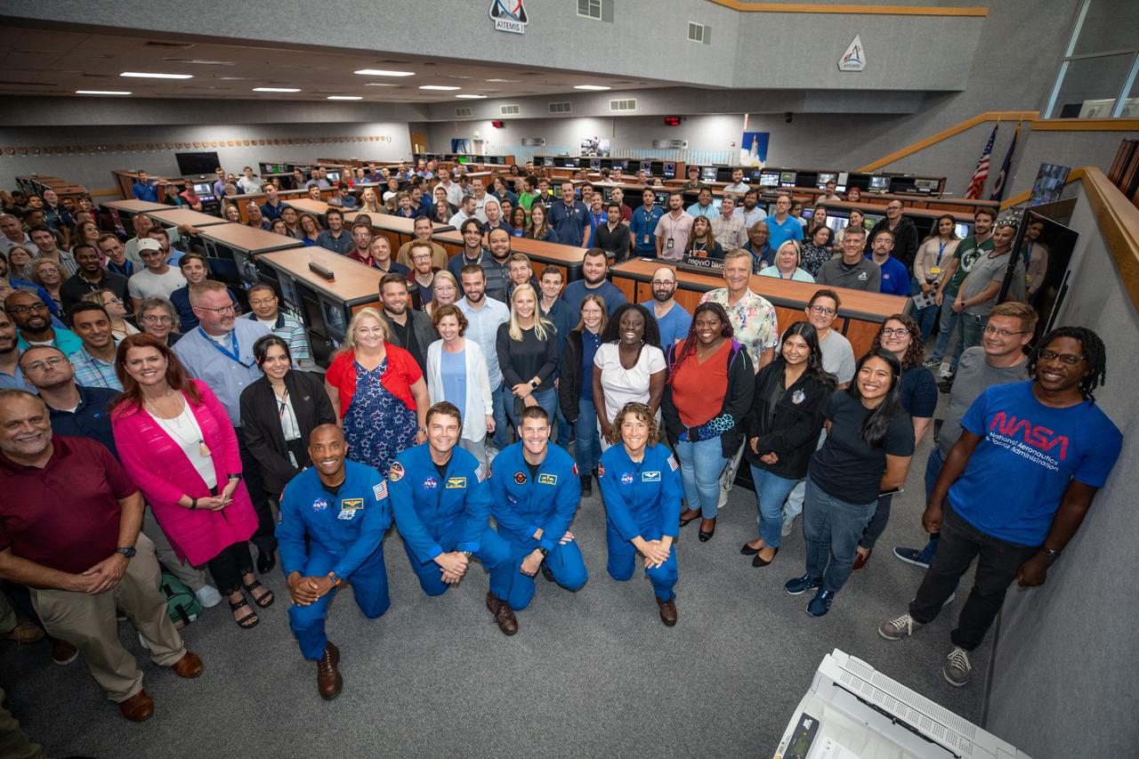 Artemis II astronauts pose for a photograph with members of the Artemis launch team inside Firing Room 1 in the Launch Control Center at NASA’s Kennedy Space Center in Florida on Aug. 7, 2023. In front, kneeling from left are NASA astronauts Victor Glover and Reid Wiseman, CSA (Canadian Space Agency) astronaut Jeremy Hansen, and NASA astronaut Christina Koch. Standing behind them, second from left is Artemis Launch Director Charlie Blackwell-Thompson. The approximately 10-day Artemis II flight will test NASA’s foundational human deep space exploration capabilities, the Space Launch System rocket and Orion spacecraft, for the first time with astronauts and will pave the way for lunar surface missions, including landing the first woman and the first person of color on the Moon. 
