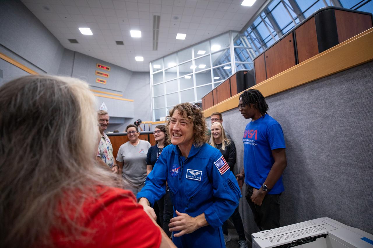 Artemis II NASA astronaut Christina Koch greets members of the Artemis launch team inside Firing Room 1 in the Launch Control at NASA’s Kennedy Space Center in Florida on Aug. 7, 2023. Koch and fellow Artemis II astronauts Victor Glover, Reid Wiseman, and CSA (Canadian Space Agency) astronaut Jeremy Hansen are at the center to meet workers and tour facilities. The approximately 10-day Artemis II flight will test NASA’s foundational human deep space exploration capabilities, the Space Launch System rocket and Orion spacecraft, for the first time with astronauts and will pave the way for lunar surface missions, including landing the first woman and the first person of color on the Moon.