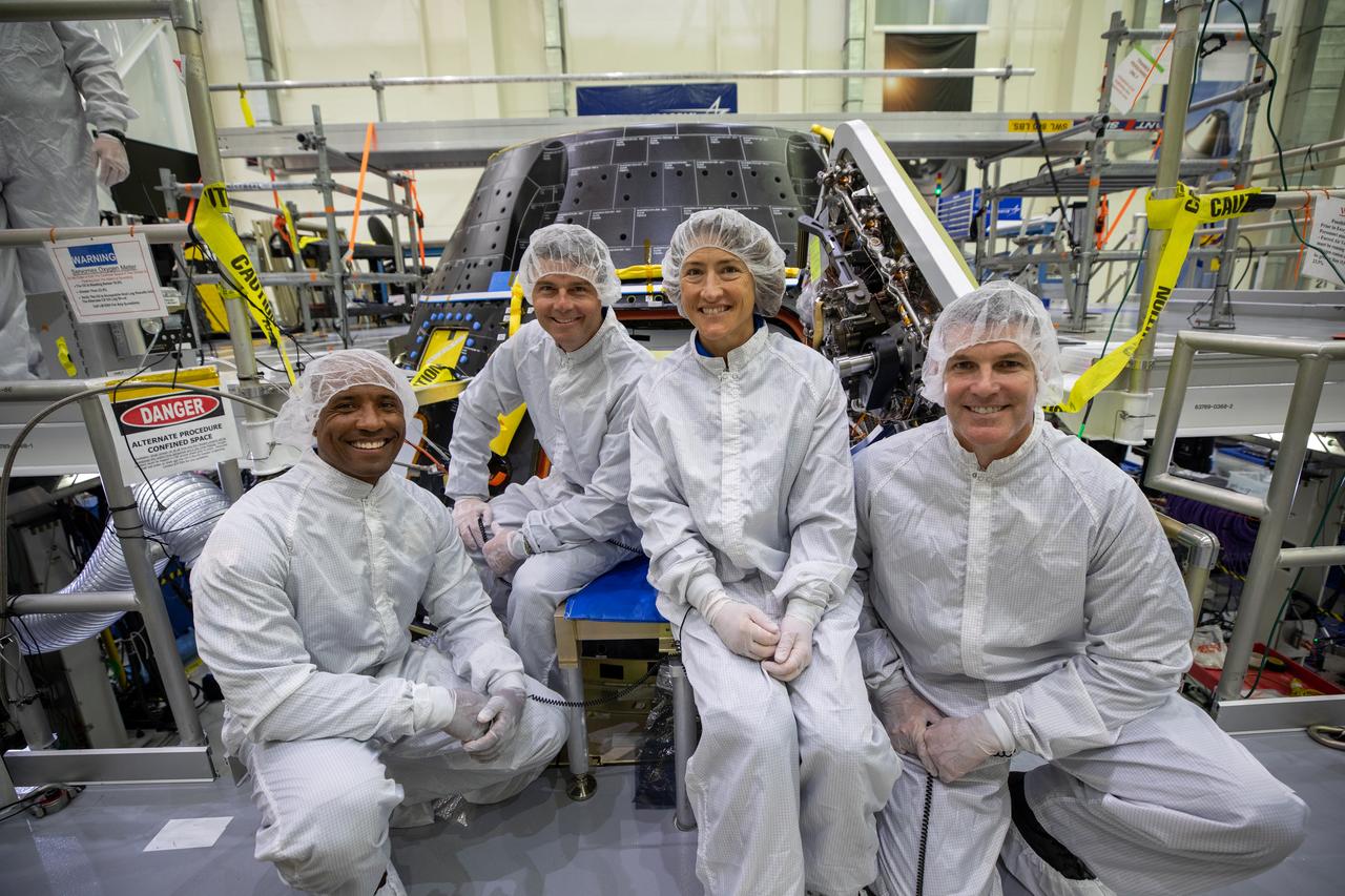 Artemis II crew members inspect their Orion crew module inside the high bay of the Neil A. Armstrong Operations and Checkout Building at NASA’s Kennedy Space Center in Florida, on Aug. 7, 2023. From left are: Victor Glover, pilot; Reid Wiseman, commander; Christina Hammock Koch, mission specialist; and Jeremy Hansen, mission specialist. The crew module is undergoing acoustic testing ahead of integration with the European Service Module. Artemis II is the first crewed mission on NASA’s path to establishing a long-term lunar presence for science and exploration under Artemis.
