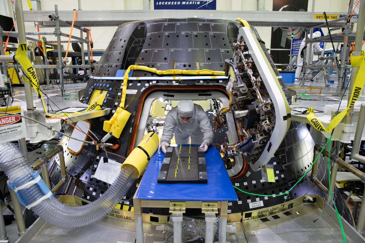 An Artemis II crew member exits the Artemis II Orion crew module inside the high bay of the Neil A. Armstrong Operations and Checkout Building at NASA’s Kennedy Space Center in Florida, on Aug. 7, 2023. The crew module is undergoing acoustic testing ahead of integration with the European Service Module. The Artemis II crew features Reid Wiseman, commander; Victor Glover, pilot; Christina Hammock Koch, mission specialist; and Jeremy Hansen, mission specialist. Artemis II is the first crewed mission on NASA’s path to establishing a long-term lunar presence for science and exploration under Artemis.