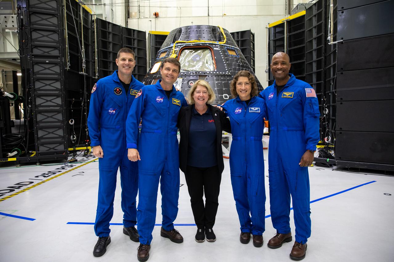 Artemis II crew members, shown inside the Neil Armstrong Operations and Checkout Building at NASA’s Kennedy Space Center in Florida, stand in front of their Orion crew module with NASA Deputy Administrator Pam Melroy on Aug. 8, 2023. From left are: Jeremy Hansen, mission specialist; Reid Wiseman, commander; and Christina Hammock Koch, mission specialist; and Victor Glover, pilot. The crew module is undergoing acoustic testing ahead of integration with the European Service Module. Artemis II is the first crewed mission on NASA’s path to establishing a long-term lunar presence for science and exploration under Artemis.