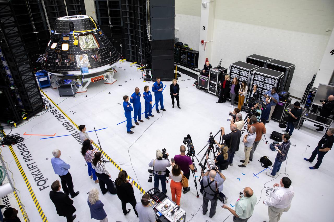 Artemis II crew members, shown inside the Neil Armstrong Operations and Checkout Building at NASA’s Kennedy Space Center in Florida, stand in front of their Orion crew module with NASA Deputy Administrator Pam Melroy during a media event on Aug. 8, 2023. From left are: Reid Wiseman, commander; Victor Glover, pilot; Christina Hammock Koch, mission specialist; and Jeremy Hansen, mission specialist. The crew module is undergoing acoustic testing ahead of integration with the European Service Module. Artemis II is the first crewed mission on NASA’s path to establishing a long-term lunar presence for science and exploration under Artemis.