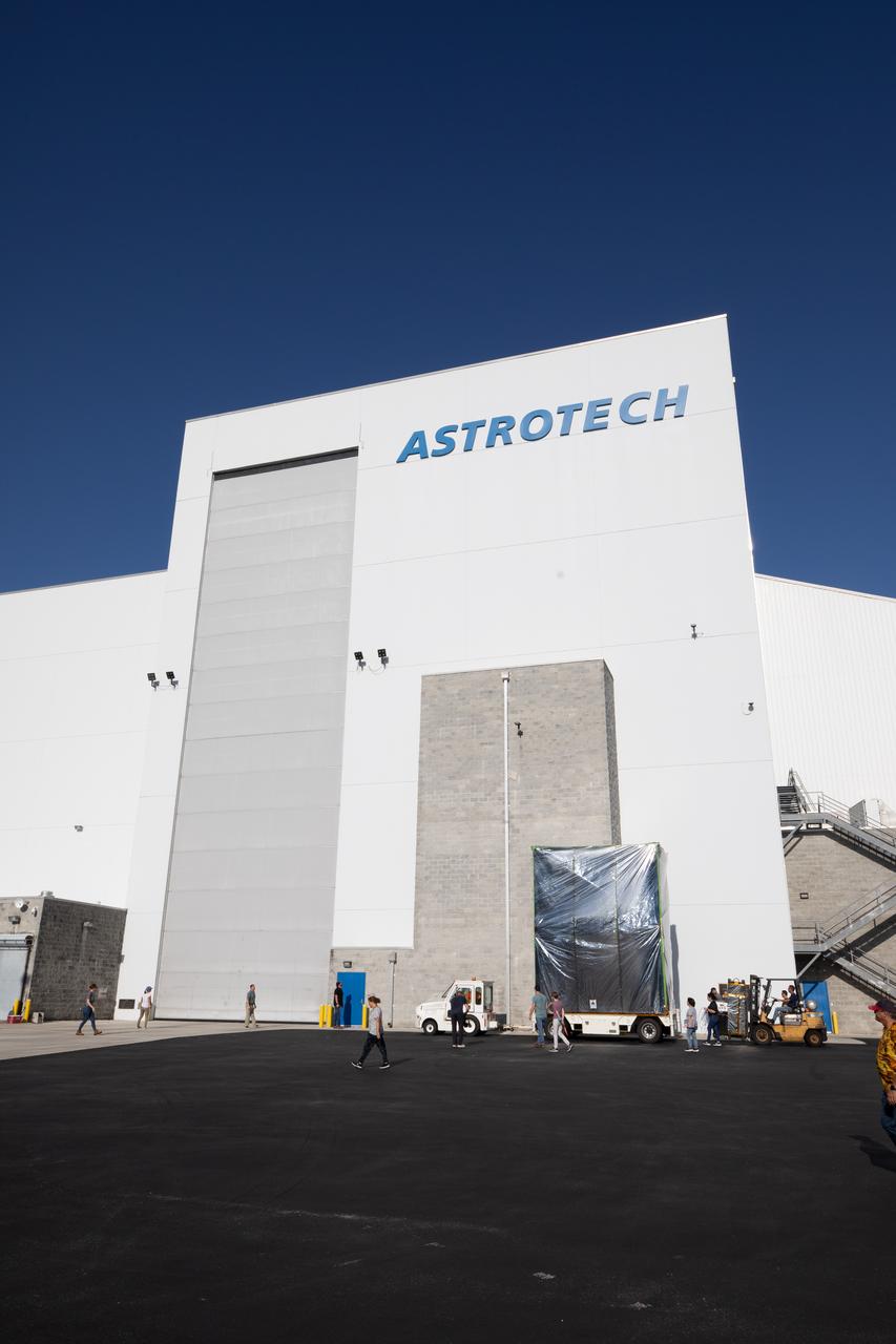 NASA’s Psyche spacecraft, secured for transport, arrived at the entrance to Building 9 at the Astrotech Space Operations Facility near the agency’s Kennedy Space Center in Florida on Aug. 14, 2023.  Psyche will explore its namesake, a metal-rich asteroid orbiting the Sun between Mars and Jupiter. Psyche has NASA’s Deep Space Optical Communications (DSOC) technology demonstration onboard the spacecraft. DSOC will be the agency's first demonstration of optical communication beyond the Moon. Psyche will launch atop a SpaceX Falcon Heavy rocket from Launch Complex 39A at Kennedy. Launch is targeted for Oct. 5, 2023. 
