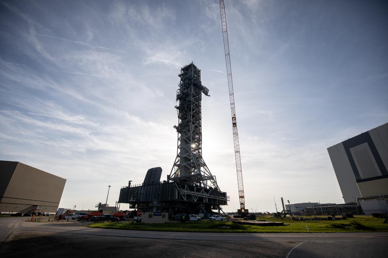 The mobile launcher, carried by the crawler-transporter 2, rolls out from its park site location to Launch Pad 39B at NASA’s Kennedy Space Center in Florida on Aug. 16, 2023. While at the pad, it will undergo testing for the agency’s Artemis II mission. Under Artemis, the mobile launcher will transport NASA’s Space Launch System rocket and Orion spacecraft to pad 39B for liftoff.
