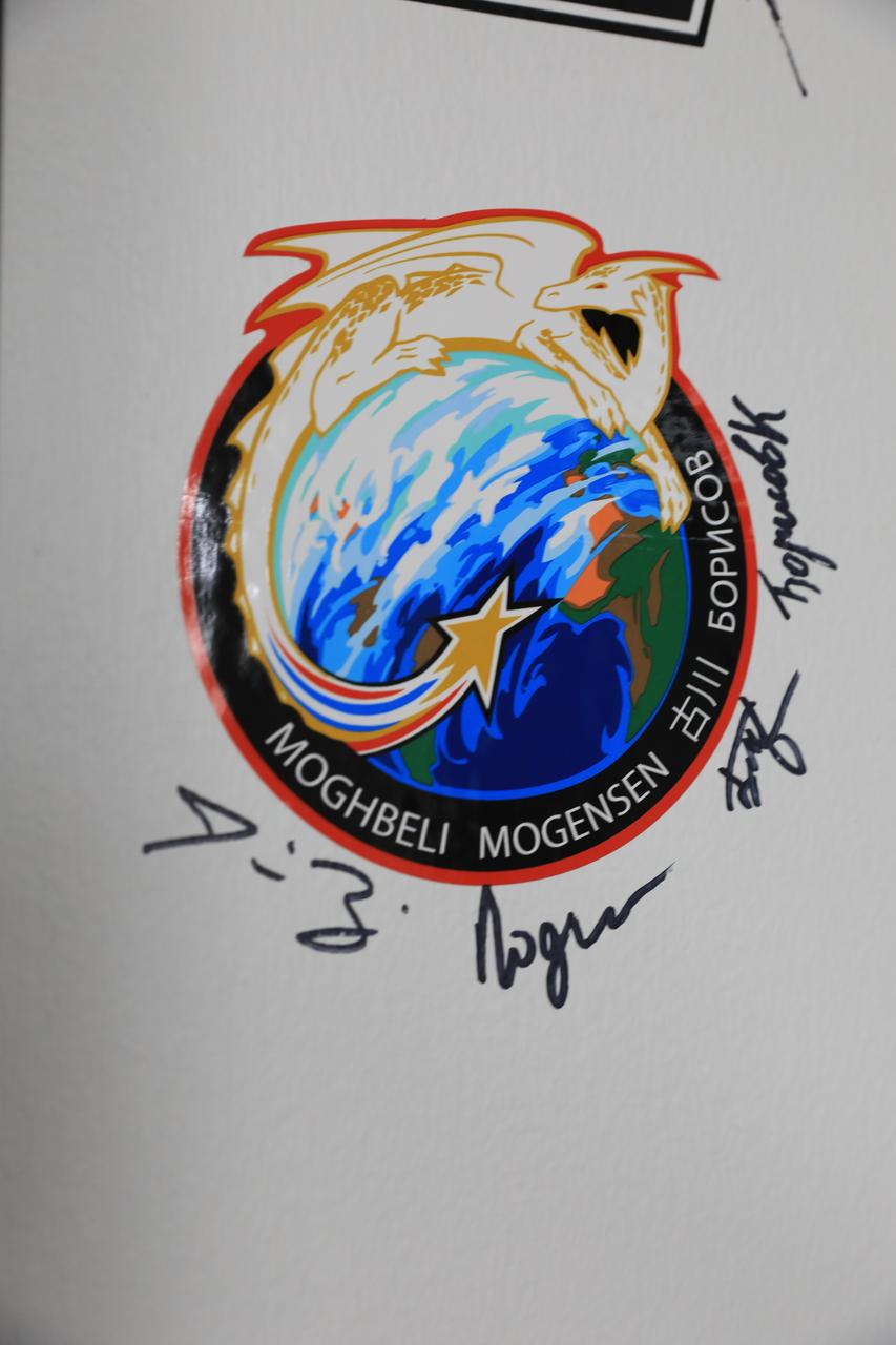 NASA’s SpaceX Crew-7 crew members add their signatures below their mission sticker in the hallway of the Astronaut Crew Quarters inside the Neil A. Armstrong Operations and Checkout Building at Kennedy Space Center in Florida on Tuesday, Aug. 22, 2023. NASA astronaut Jasmin Moghbeli, ESA (European Space Agency) astronaut Andreas Mogensen, JAXA (Japan Aerospace Exploration Agency) astronaut Satoshi Furukawa, and Roscosmos cosmonaut Konstantin Borisov will launch to the International Space Station aboard SpaceX’s Dragon spacecraft and Falcon 9 rocket. Liftoff is targeted for 3:49 a.m. EDT Friday, Aug. 25, 2023, from Kennedy’s Launch Complex 39A.
