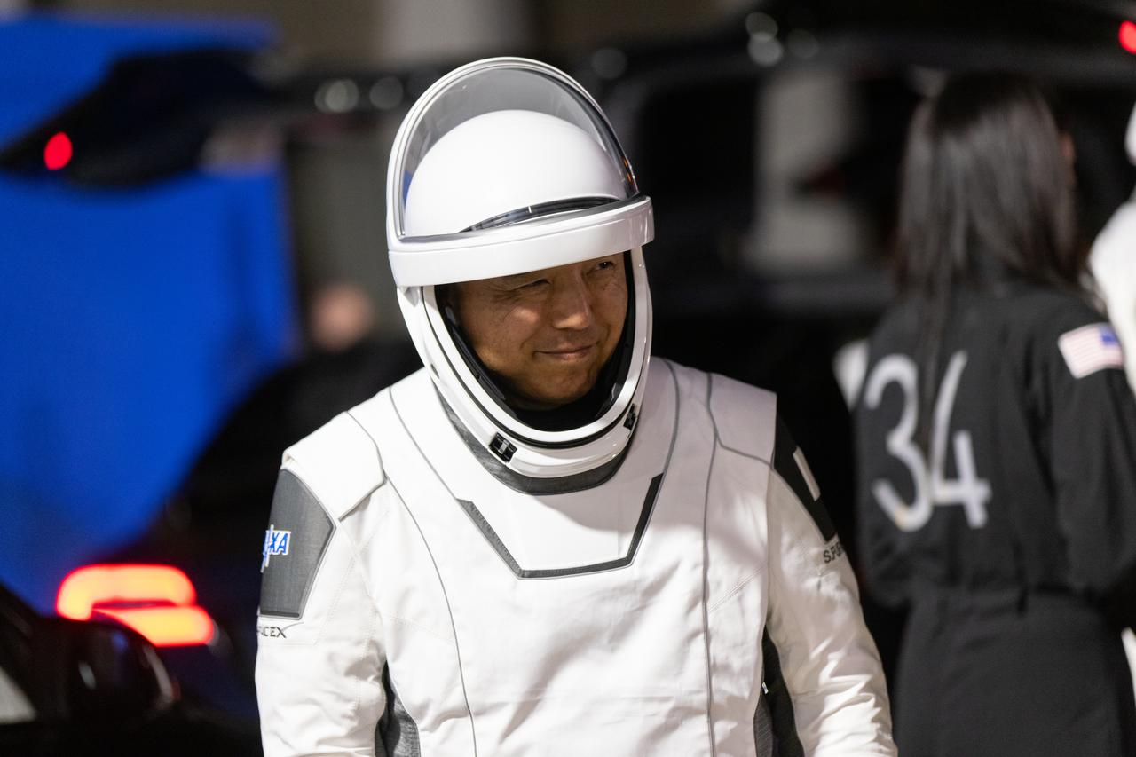 NASA’s SpaceX Crew-7 JAXA (Japan Aerospace Exploration Agency) astronaut Satoshi Furukawa smiles outside of the Neil Armstrong Operations and Checkout Building at NASA’s Kennedy Space Center in Florida on Saturday, Aug. 26, 2023. Furukawa and his crewmates are preparing to get into the customized Tesla Model X vehicles that will transport them to Kennedy’s Launch Complex 39A. SpaceX’s Dragon spacecraft, powered by the company’s Falcon 9 rocket, will carry the four-person crew – which includes NASA astronaut Jasmin Moghbeli, ESA (European Space Agency) astronaut Andreas Mogensen, and Roscosmos cosmonaut Konstantin Borisov – to the International Space Station as part of NASA’s Commercial Crew Program. Crew-7 is scheduled to launch at 3:27 a.m. EDT. 