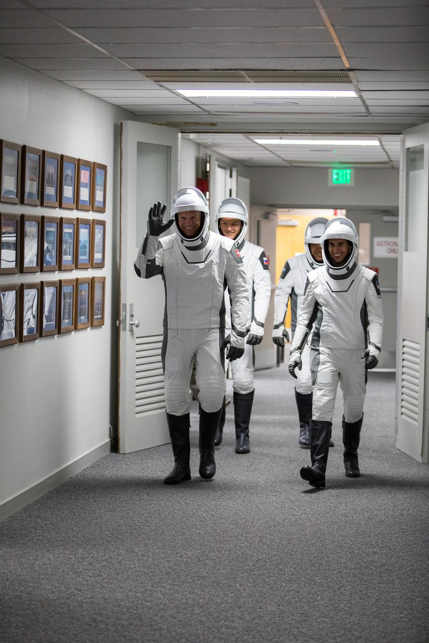 NASA’s SpaceX Crew-7 crew members walk down the hallway of the Neil A. Armstrong Operations and Checkout Building on Saturday, Aug. 26, 2023, at the agency’s Kennedy Space Center in Florida. From left, front to back, are ESA (European Space Agency) astronaut Andreas Mogensen, NASA astronaut Jasmin Moghbeli, Roscosmos cosmonaut Konstantin Borisov, and JAXA (Japan Aerospace Exploration Agency) astronaut Satoshi Furukawa. They will board two Tesla vehicles for the trip to Kennedy’s Launch Complex 39A, where they will launch to the International Space Station aboard SpaceX’s Dragon spacecraft and Falcon 9 rocket. Liftoff is at 3:27 a.m. EDT.