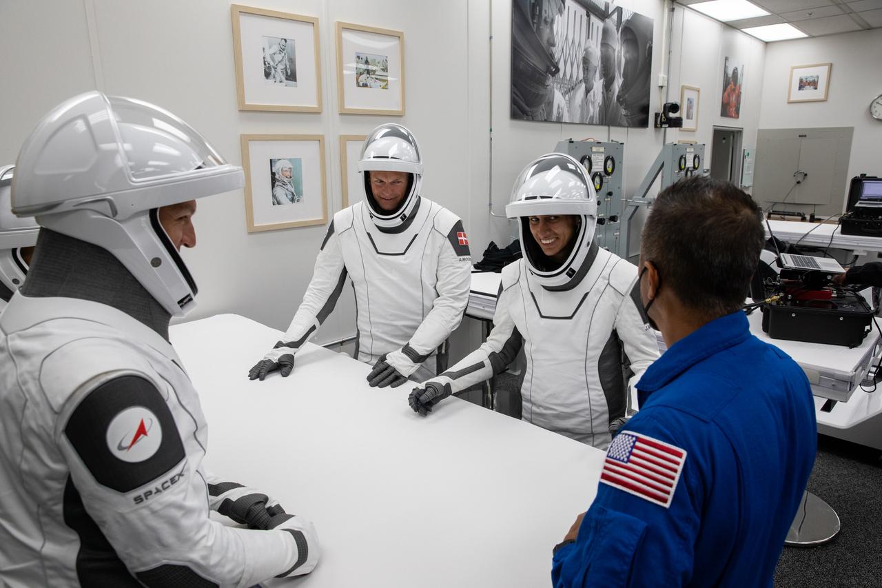 NASA’s SpaceX Crew-7 crew members Jasmin Moghbeli, Andreas Mogensen, Satoshi Furukawa, and Konstantin Borisov play a traditional card game on Saturday, Aug. 26, 2023, inside the suit-up room in the Neil Armstrong Operations and Checkout Building at NASA’s Kennedy Space Center in Florida. Next, they will get into the customized Tesla Model X vehicles that will transport them to Kennedy’s Launch Complex 39A. SpaceX’s Dragon spacecraft, powered by the company’s Falcon 9 rocket, will carry the four-person crew to the International Space Station as part of NASA’s Commercial Crew Program. Crew-7 is scheduled to launch at 3:27 a.m. EDT.