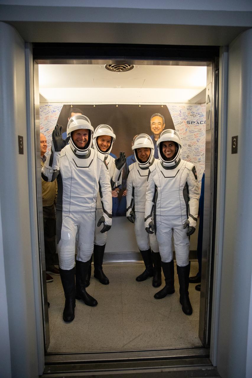 NASA’s SpaceX Crew-7 mission crew members, from left, ESA (European Space Agency) astronaut Andreas Mogensen, Roscosmos cosmonaut Konstantin Borisov, JAXA (Japan Aerospace Exploration Agency) astronaut Satoshi Furukawa, and NASA astronaut Jasmin Moghbeli enter the elevator in the Astronaut Crew Quarters on Saturday, Aug. 26, 2023, inside Kennedy Space Center’s Neil A. Armstrong Operations and Checkout Building. A team of SpaceX suit technicians assisted the crew as they put on their custom-fitted spacesuits and checked the suits for leaks. The crew members will launch aboard SpaceX’s Dragon spacecraft and Falcon 9 rocket to the International Space Station as part of NASA’s Commercial Crew Program. Liftoff is targeted for 3:27 a.m. EDT from Launch Complex 39A at the Florida spaceport. 