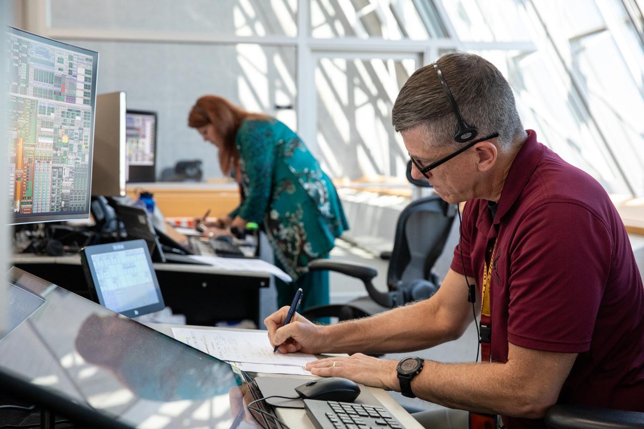 NASA Artemis Launch Director Charlie Blackwell-Thompson, left, and Assistant Artemis Launch Director Jeremy Graeber monitor activities during the Artemis II terminal countdown simulation inside Firing Room 1 in the Launch Control Center at NASA’s Kennedy Space Center in Florida on Monday, Sept. 11, 2023. Members of the Artemis II launch team include personnel with NASA’s Exploration Ground Systems and contractor Jacobs. This is part of a series of simulations to help the team prepare for the launch of Artemis II, the first mission with astronauts under Artemis that will test and check out all of the Orion spacecraft’s systems needed for future crewed missions.