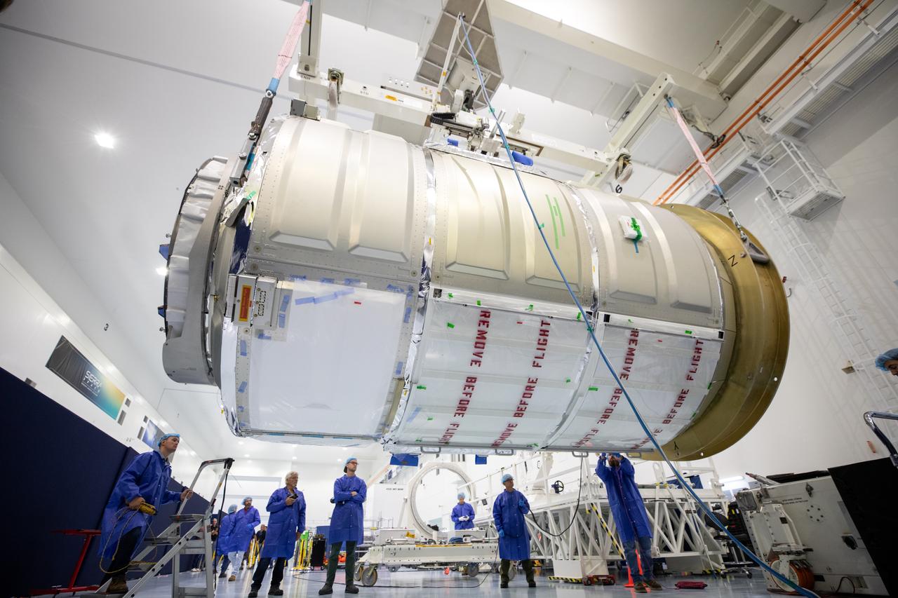 The Northrop Grumman Cygnus spacecraft’s pressurized cargo module (PCM) for the company’s 20th commercial resupply mission is lifted and moved by crane inside the high bay in the Space Station Processing Facility at NASA’s Kennedy Space Center in Florida on Monday, Sept. 18, 2023. The next step is vehicle processing for the mission to the International Space Station. Liftoff, aboard a SpaceX Falcon 9 rocket, will be from Cape Canaveral Space Force Station’s Space Launch Complex 40.