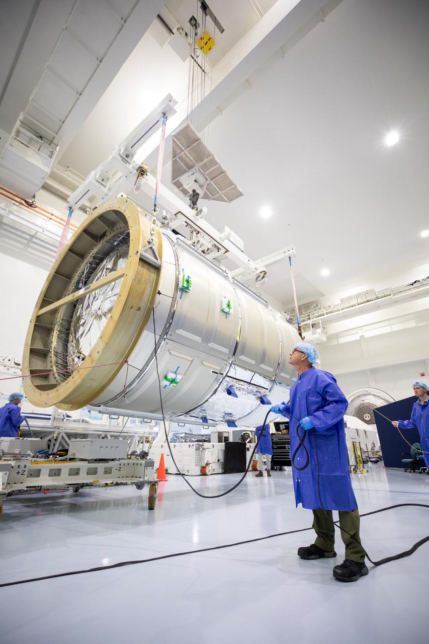 The Northrop Grumman Cygnus spacecraft’s pressurized cargo module (PCM) for the company’s 20th commercial resupply mission is lifted and moved by crane inside the high bay in the Space Station Processing Facility at NASA’s Kennedy Space Center in Florida on Monday, Sept. 18, 2023. The next step is vehicle processing for the mission to the International Space Station. Liftoff, aboard a SpaceX Falcon 9 rocket, will be from Cape Canaveral Space Force Station’s Space Launch Complex 40.