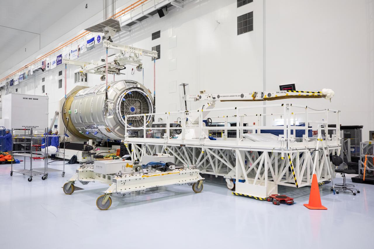 The Northrop Grumman Cygnus spacecraft’s pressurized cargo module (PCM) for the company’s 20th commercial resupply mission is lifted and moved by crane inside the high bay in the Space Station Processing Facility at NASA’s Kennedy Space Center in Florida on Monday, Sept. 18, 2023. The next step is vehicle processing for the mission to the International Space Station. Liftoff, aboard a SpaceX Falcon 9 rocket, will be from Cape Canaveral Space Force Station’s Space Launch Complex 40.