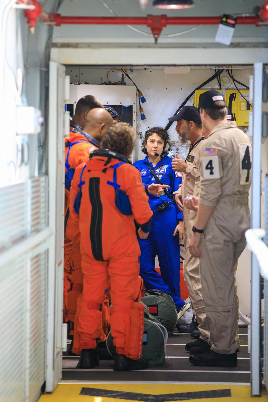 Artemis II NASA astronauts Reid Wiseman, Victor Glover, and Christina Koch, and CSA (Canadian Space Agency) astronaut Jeremy Hansen stand in the white room with fellow NASA astronaut Jessica Meir and closeout team members on the crew access arm of the mobile launcher at Launch Pad 39B as part of an integrated ground systems test at Kennedy Space Center in Florida on Wednesday, Sept. 20, 2023. The test ensures the ground systems team is ready to support the crew timeline on launch day.
