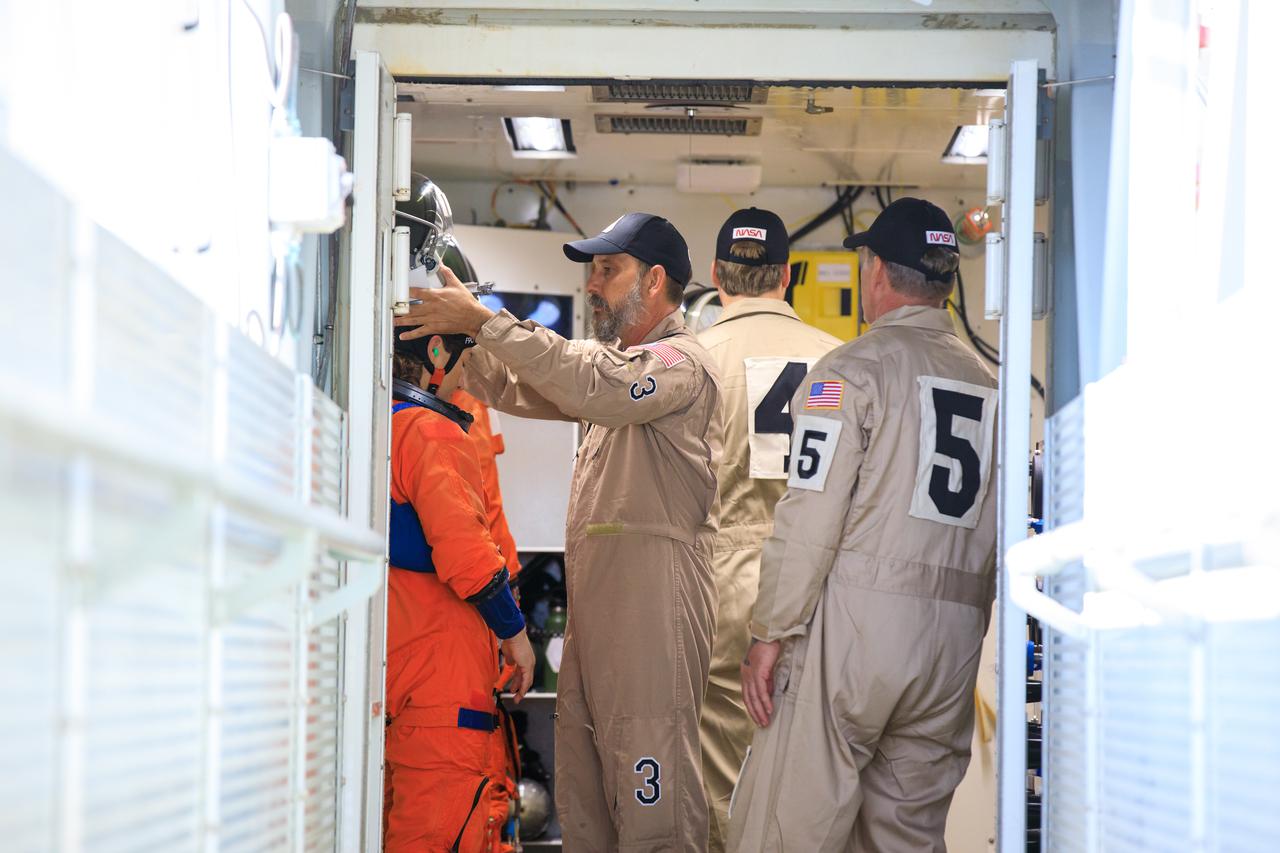 Artemis II NASA astronauts Reid Wiseman, Victor Glover, and Christina Koch, and CSA (Canadian Space Agency) astronaut Jeremy Hansen stand in the white room on the crew access arm of the mobile launcher at Launch Pad 39B as part of an integrated ground systems test at Kennedy Space Center in Florida on Wednesday, Sept. 20, 2023. The test ensures the ground systems team is ready to support the crew timeline on launch day.