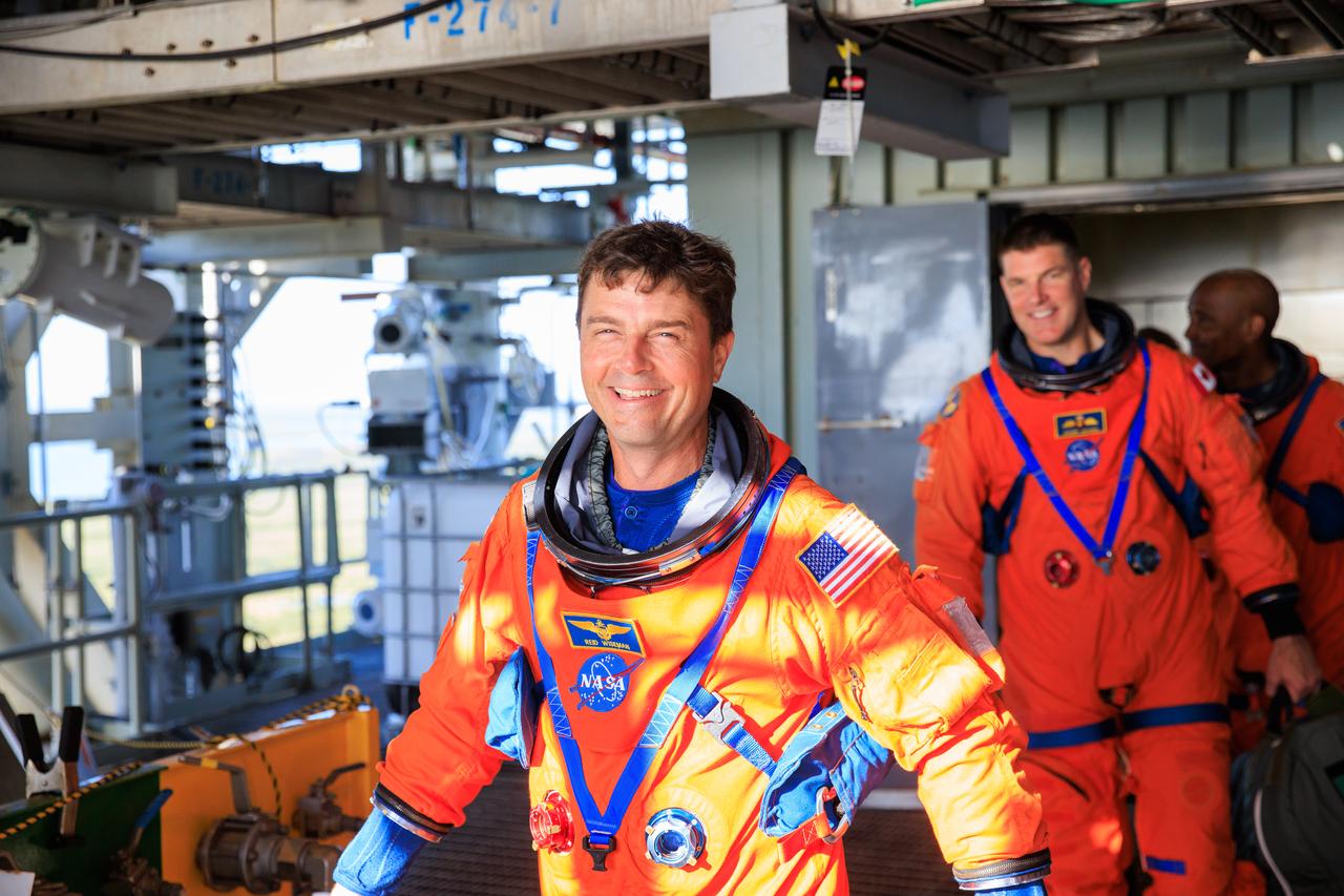 Artemis II astronauts (front to back) NASA astronaut Reid Wiseman, CSA (Canadian Space Agency) astronaut Jeremy Hansen, and NASA astronaut Victor Glover stand on the mobile launcher at Launch Pad 39B as part of an integrated ground systems test at Kennedy Space Center in Florida on Wednesday, Sept. 20. The test ensures the ground systems team is ready to support the crew timeline on launch day.