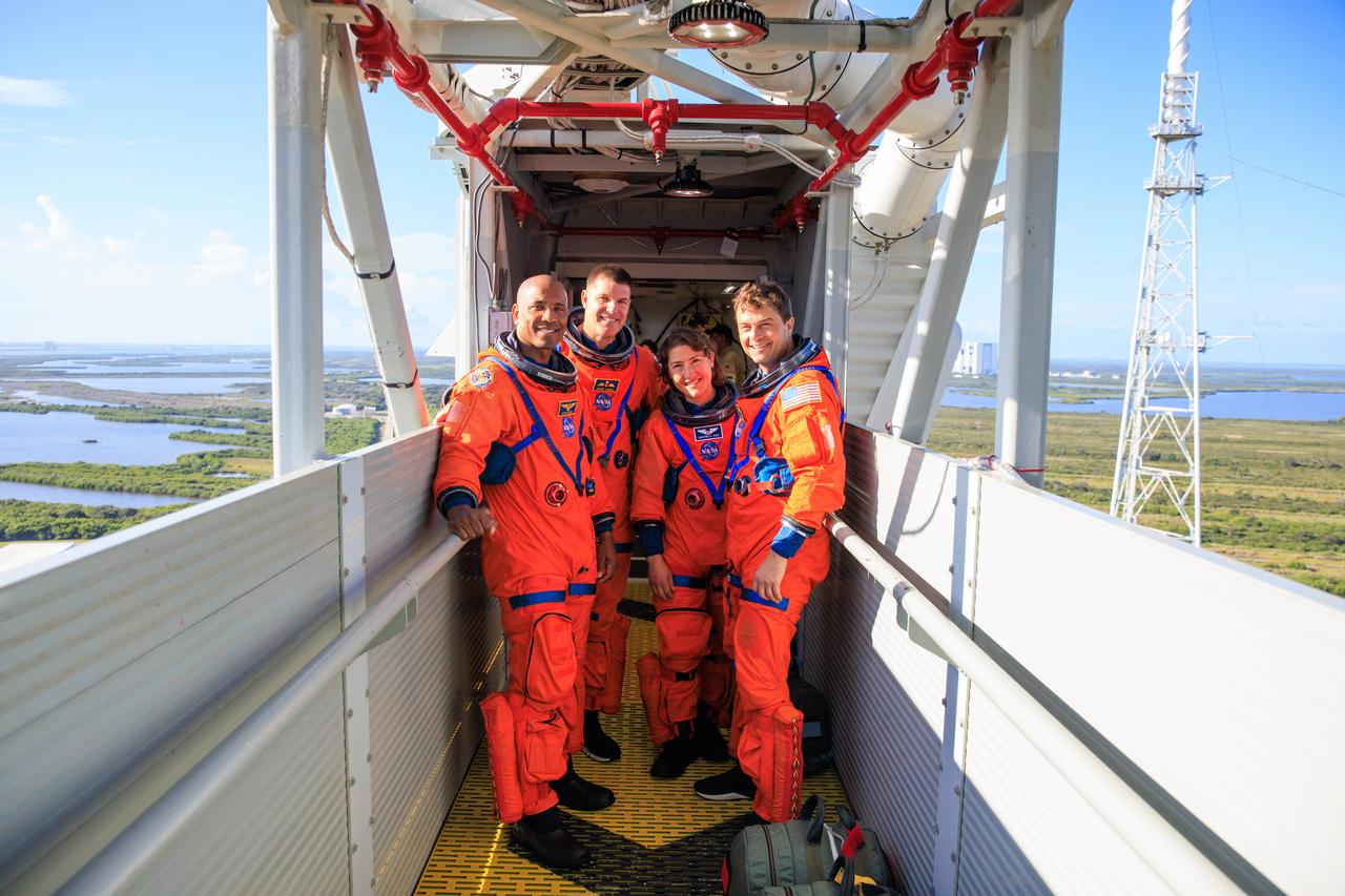 Artemis II astronauts, from left, NASA astronaut Victor Glover (left), CSA (Canadian Space Agency) astronaut Jeremy Hansen, NASA astronauts Christina Koch and Reid Wiseman stand on the crew access arm of the mobile launcher at Launch Pad 39B as part of an integrated ground systems test at Kennedy Space Center in Florida on Wednesday, Sept. 20. The test ensures the ground systems team is ready to support the crew timeline on launch day.