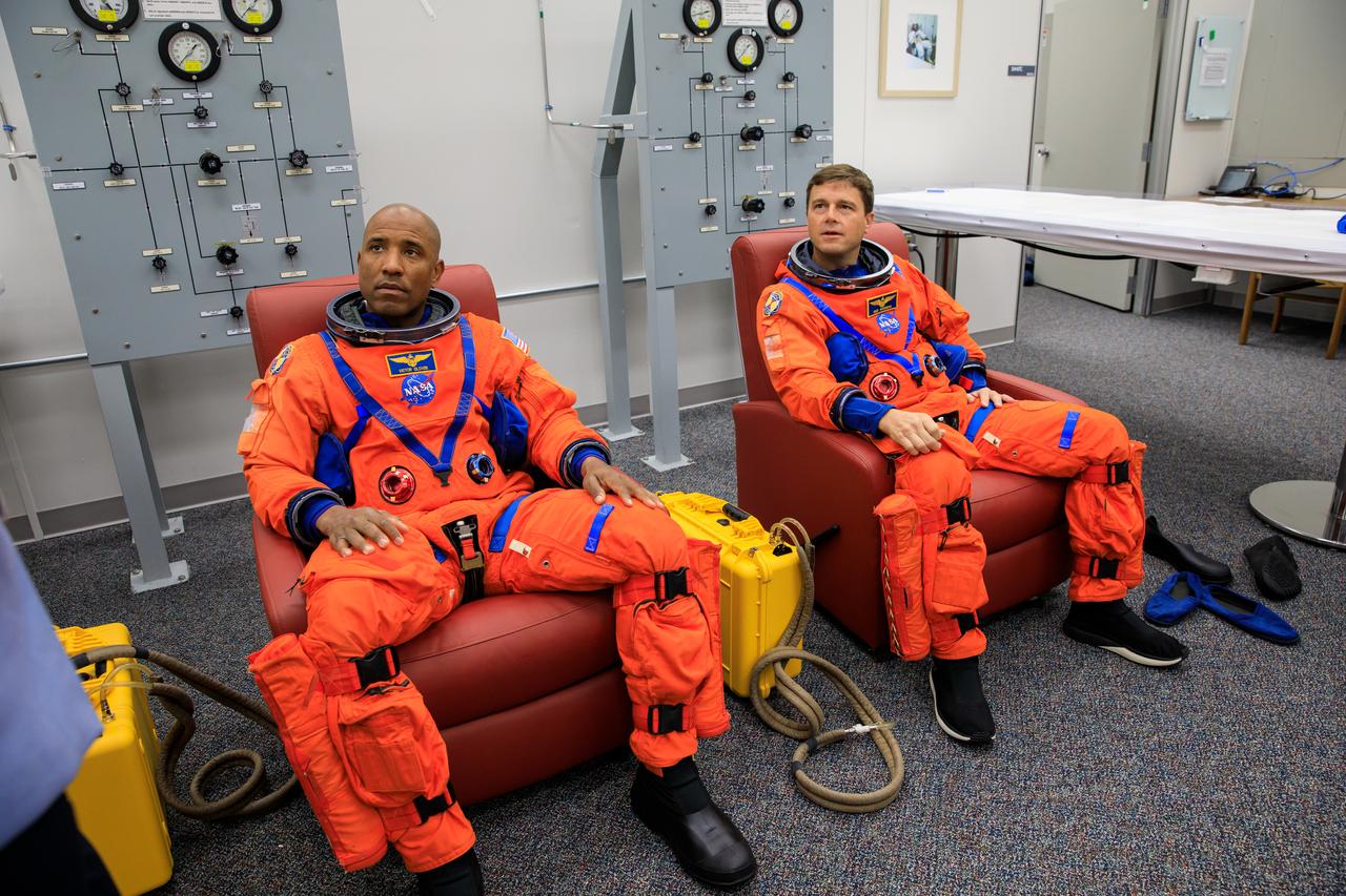 Inside the Astronaut Crew Quarters at the Neil Armstrong Operations and Checkout Building at NASA’s Kennedy Space Center in Florida, Artemis II crew members NASA astronauts Victor Glover (left) and Reid Wiseman are shown wearing test versions of the Orion crew survival system spacesuits they will wear on launch day as part of an integrated ground systems test on Wednesday, Sept. 20. 