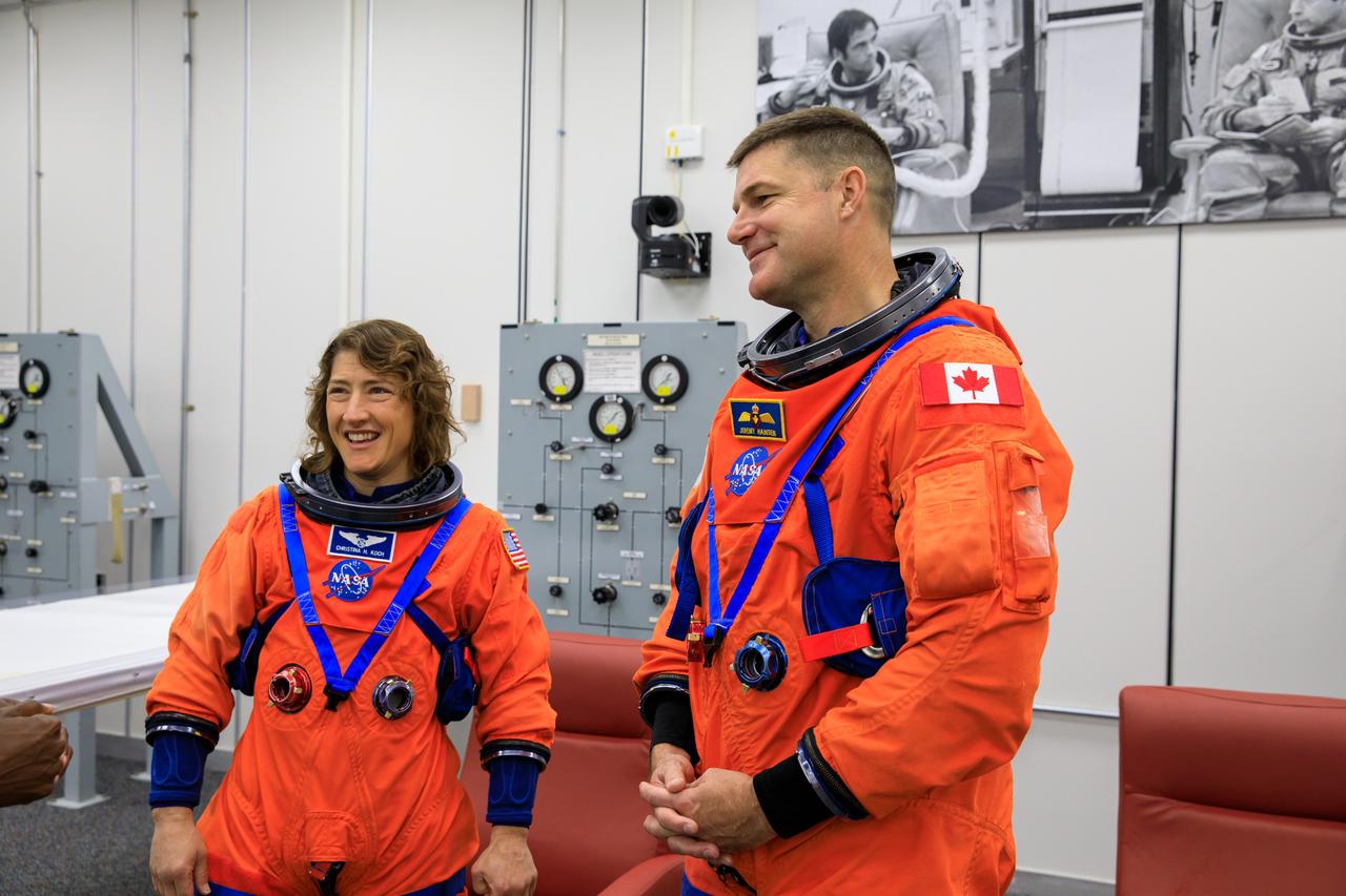 Inside the Astronaut Crew Quarters at the Neil Armstrong Operations and Checkout Building at NASA’s Kennedy Space Center in Florida, Artemis II crew members NASA astronaut Christina Koch (left) and CSA (Canadian Space Agency) astronaut Jeremy Hansen are shown wearing test versions of the Orion crew survival system spacesuits they will wear on launch day as part of an integrated ground systems test on Wednesday, Sept. 20. 