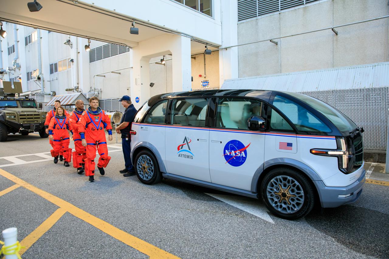 Artemis II crew members (front to back) NASA astronauts Reid Wiseman, Victor Glover, and Christina Koch, and CSA (Canadian Space Agency) astronaut Jeremy Hansen walk out of Astronaut Crew Quarters inside the Neil Armstrong Operations and Checkout Building to the Artemis crew transportation vehicles prior to traveling to Launch Pad 39B as part of an integrated ground systems test at Kennedy Space Center in Florida on Wednesday, Sept. 20, to test the crew timeline for launch day.