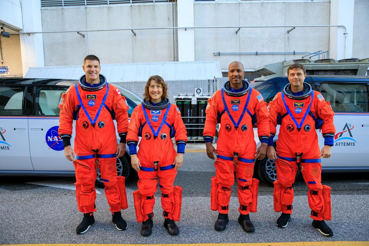 Artemis II crew members (from left) CSA (Canadian Space Agency) astronaut Jeremy Hansen, and NASA astronauts Christina Koch, Victor Glover, and Reid Wiseman walk out of Astronaut Crew Quarters inside the Neil Armstrong Operations and Checkout Building to the Artemis crew transportation vehicles prior to traveling to Launch Pad 39B as part of an integrated ground systems test at Kennedy Space Center in Florida on Wednesday, Sept. 20, to test the crew timeline for launch day.