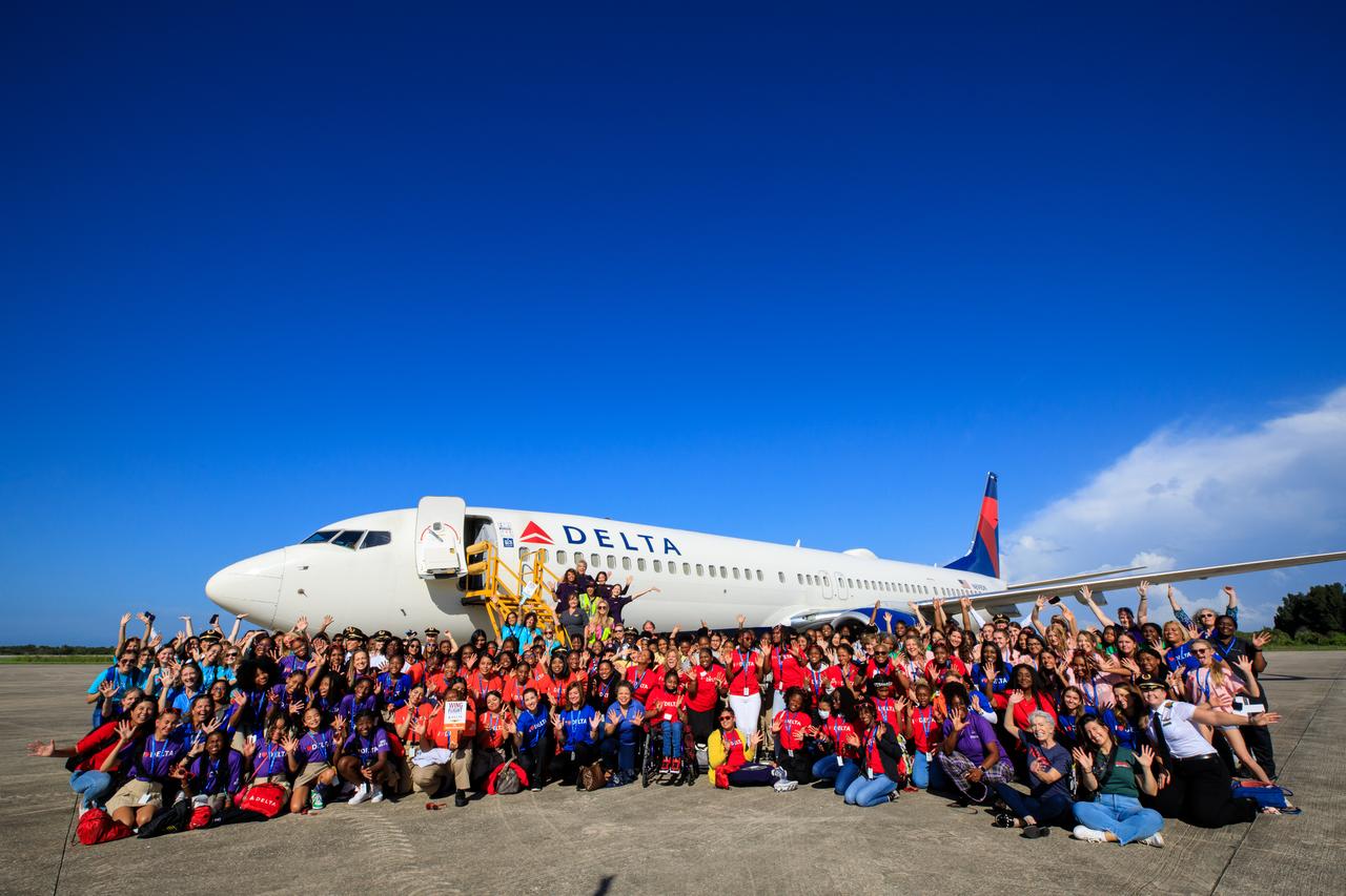 Students from various schools and organizations with a STEM (science, technology, engineering, math) focus are photographed with employees from NASA’s Kennedy Space Center at the Launch and Landing Facility following their arrival to Kennedy on Friday, Sept. 22, 2023, as part of Delta Air Lines’ Women Inspiring Our Next Generation (WING) flight. The all-female flight crew brought girls from Atlanta, Georgia, ranging in age from 12 to 18, to learn about the various careers available at the Florida spaceport. While at Kennedy, the group had the opportunity to view center facilities, hear from a panel of women with a combination of careers from Kennedy and Delta, and tour the visitor complex.