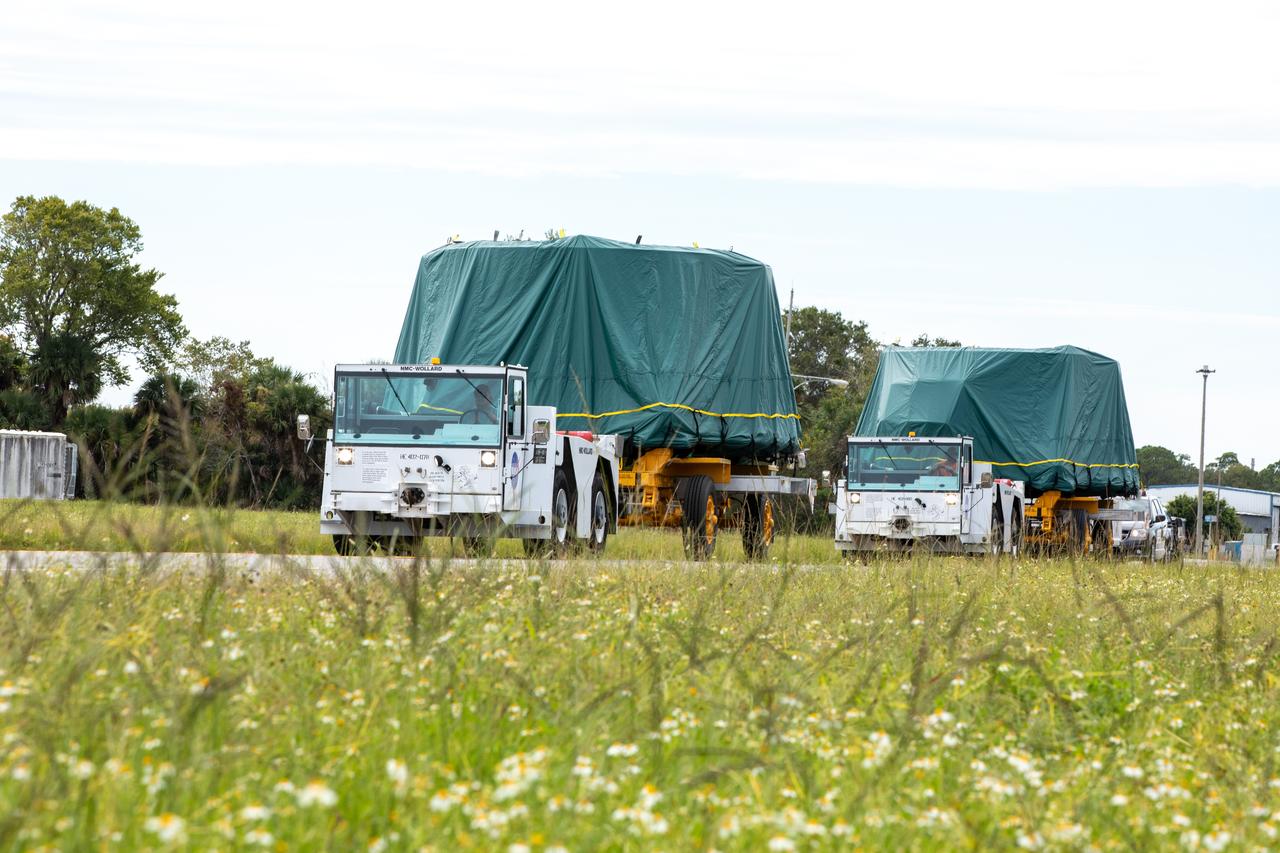 The Artemis II aft skirts for NASA's Space Launch System (SLS) rocket’s twin solid rocket boosters are transported from the Booster Fabrication Facility to the Rotation Processing and Surge Facility (RPSF) at the agency’s Kennedy Space Center in Florida on Monday, Sept. 25, 2023. The aft skirts were refurbished by Northrop Grumman and house the thrust vector control system, which controls 70 percent of the steering during initial ascent of the SLS rocket. The segments will remain in the RPSF until ready for stacking with the forward and aft parts of the boosters on the mobile launcher in High Bay 3 of the Vehicle Assembly Building. Artemis II astronauts Reid Wiseman, Victor Glover, Christina Koch, and Jeremy Hansen will launch from Kennedy, traveling around the Moon on the first crewed mission under Artemis that will test all of the Orion spacecraft’s systems.