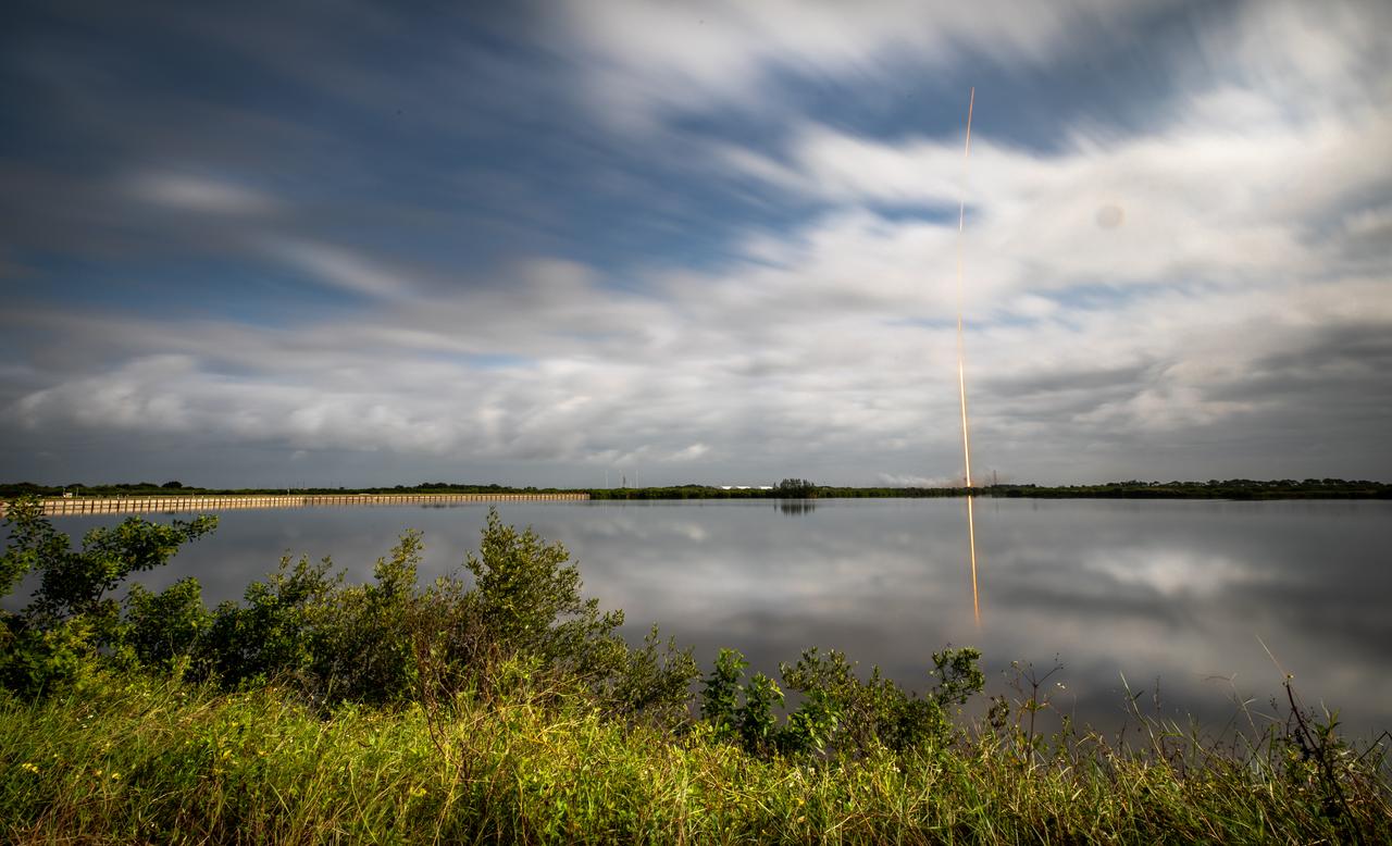 NASA’s Psyche spacecraft, atop a SpaceX Falcon Heavy rocket, soars into the sky after lifting off from Kennedy Space Center’s historic Launch Complex 39A in Florida at 10:19 a.m. EDT on Friday, Oct. 13, 2023. This daytime long exposure photo was taken from Kennedy’s Press Site near the historic countdown clock. The Psyche mission will study a metal-rich asteroid with the same name, located in the main asteroid belt between Mars and Jupiter. This is NASA’s first mission to study an asteroid that has more metal than rock or ice. Riding with Psyche is a pioneering technology demonstration – NASA’s Deep Space Optical Communications (DSOC) experiment – which will be the first test of laser communications beyond the Moon.
