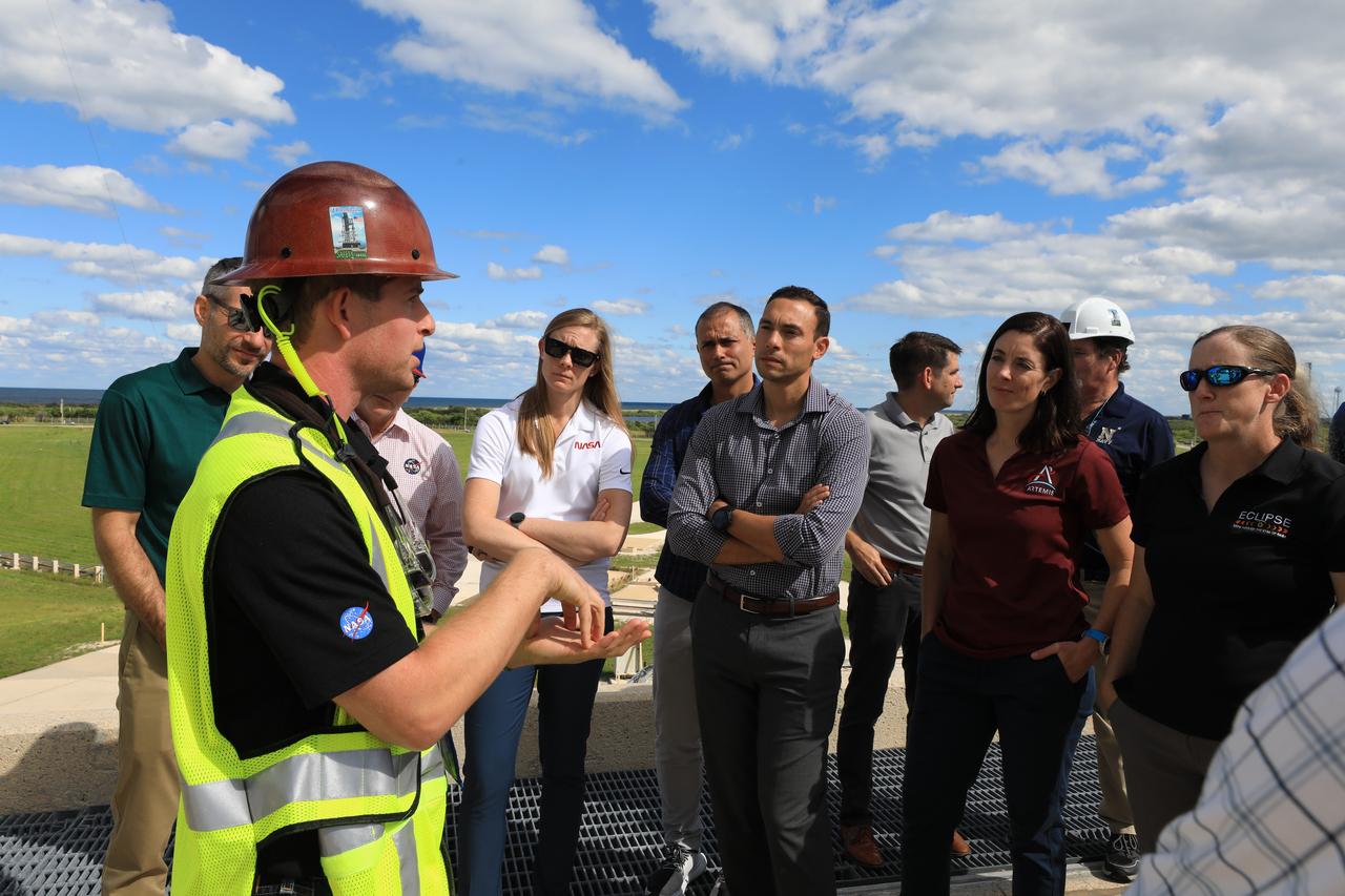 NASA’s 2021 class of astronaut candidates talk with Exploration Ground Systems engineers atop the mobile launcher at Launch Complex 39B during a familiarization tour of facilities on Monday, Oct. 16, 2023, at the agency’s Kennedy Space Center in Florida. 