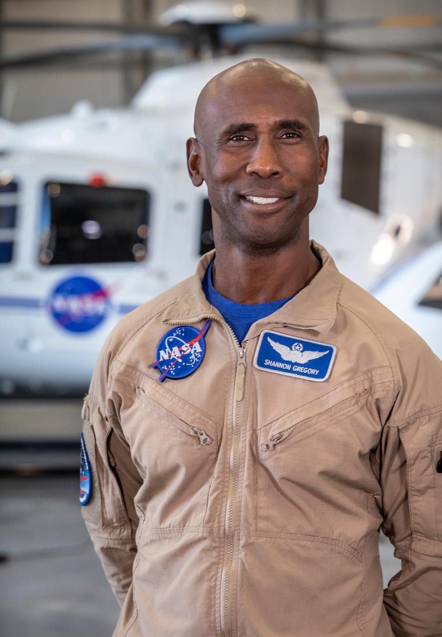 Shannon Gregory, chief of Flight Operations at NASA’s Kennedy Space Center, stands in front of one of the agency’s Airbus H135 (T3) helicopters inside a hangar at Kennedy’s Launch and Landing Facility in Florida on Tuesday, Oct. 17, 2023. Gregory leads his team to provide support at launches and recoveries, securing the airspace, shooting video, and coordinating with mission control. 