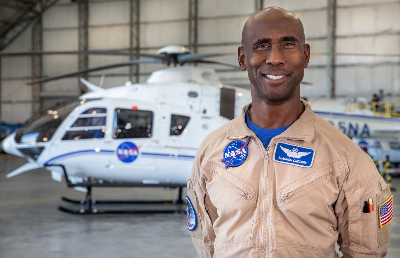 Shannon Gregory, chief of Flight Operations at NASA’s Kennedy Space Center, stands in front of one of the agency’s Airbus H135 (T3) helicopters inside a hangar at Kennedy’s Launch and Landing Facility in Florida on Tuesday, Oct. 17, 2023. Gregory leads his team to provide support at launches and recoveries, securing the airspace, shooting video, and coordinating with mission control. 