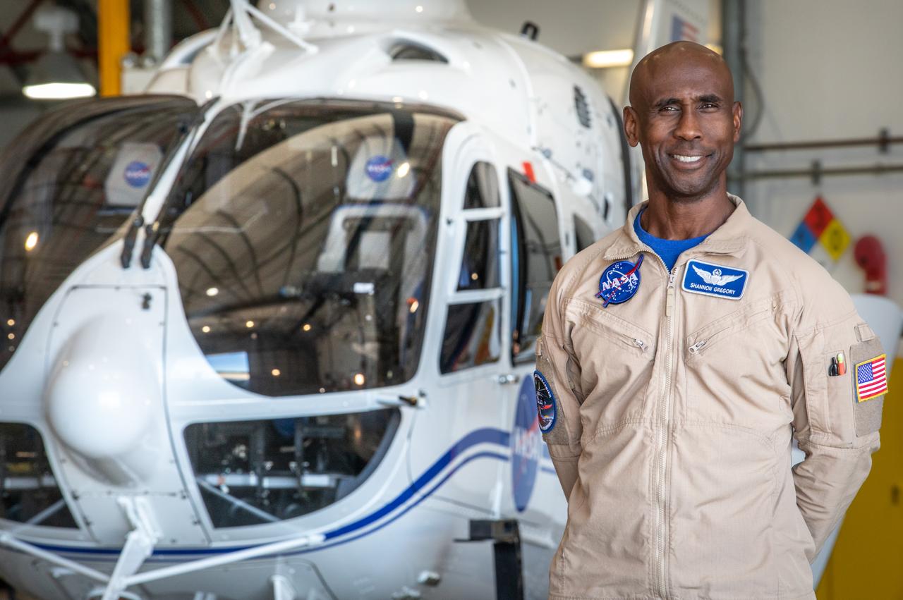 Shannon Gregory, chief of Flight Operations at NASA’s Kennedy Space Center, stands in front of one of the agency’s Airbus H135 (T3) helicopters inside a hangar at Kennedy’s Launch and Landing Facility in Florida on Tuesday, Oct. 17, 2023. Gregory leads his team to provide support at launches and recoveries, securing the airspace, shooting video, and coordinating with mission control. 