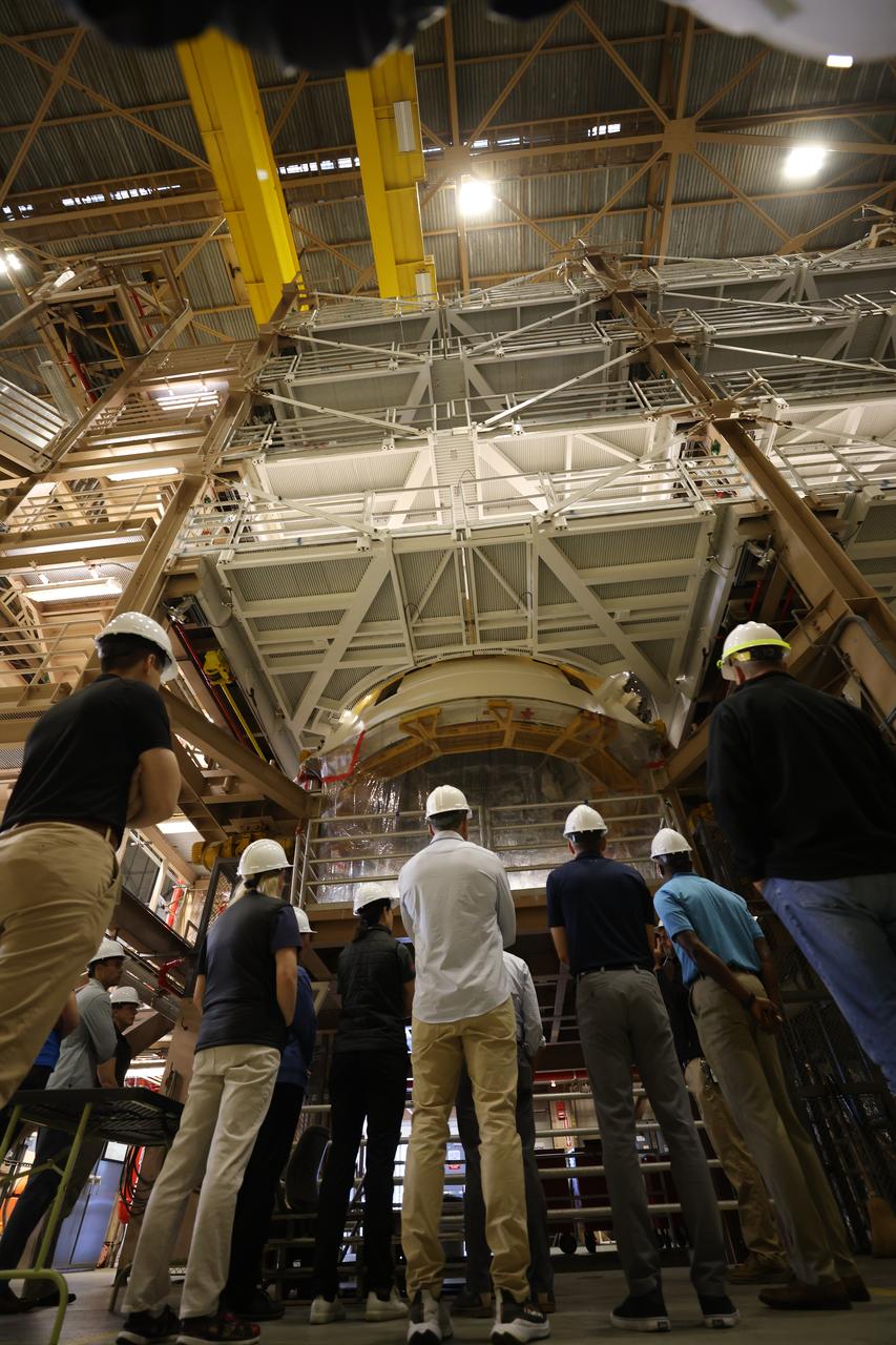 NASA’s 2021 class of astronaut candidates view a booster segment for Artemis II inside the Rotation, Processing and Surge Facility during a familiarization tour of facilities on Tuesday, Oct. 17, 2023, at the agency’s Kennedy Space Center in Florida. 