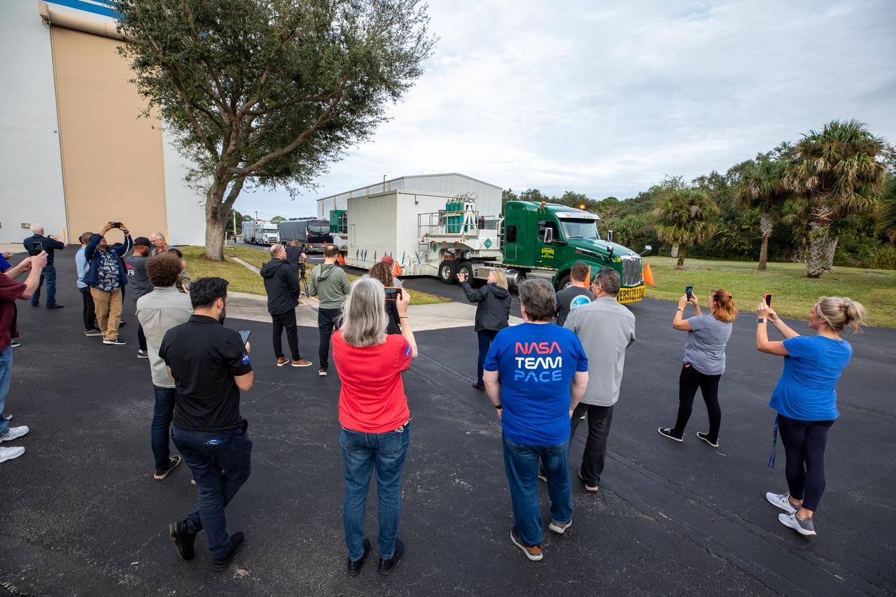 The transport carrier containing NASA’s Plankton, Aerosol, Cloud, ocean Ecosystem (PACE) observatory spacecraft arrives at the Astrotech Space Operations Facility near the agency’s Kennedy Space Center in Florida on Tuesday, Nov. 14, 2023. PACE was shipped from the agency’s Goddard Space Flight Center in Greenbelt, Maryland, and is targeted to launch on January 30, 2024, on a SpaceX Falcon 9 rocket lifting off from Space Launch Complex 40 at Cape Canaveral Space Force Station. The PACE observatory will help us better understand how the ocean and atmosphere exchange carbon dioxide, measure key atmospheric variables associated with air quality and Earth's climate, and monitor ocean health, in part by studying phytoplankton, tiny plants and algae that sustain the marine food web. 