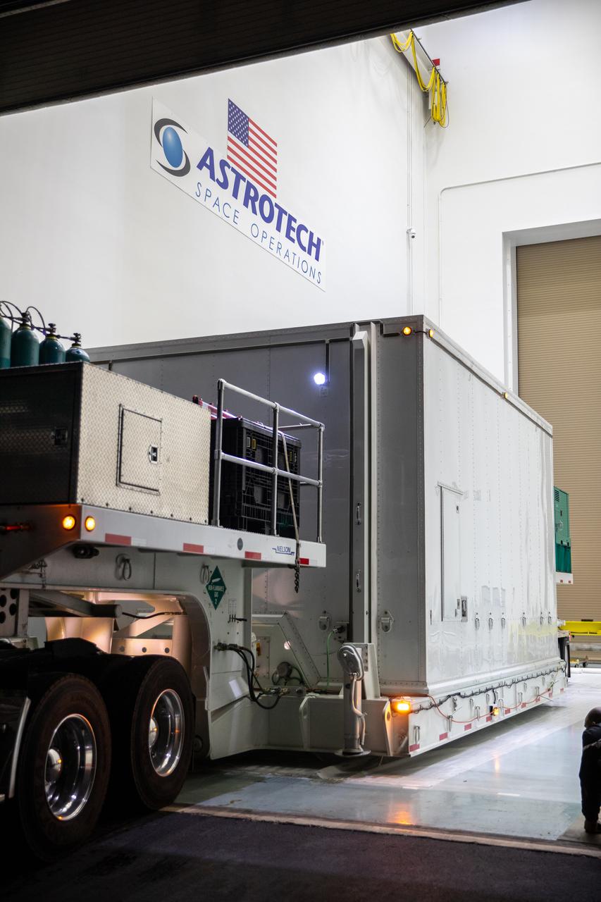 The transport carrier containing NASA’s Plankton, Aerosol, Cloud, ocean Ecosystem (PACE) observatory spacecraft is offloaded at the Astrotech Space Operations Facility near the agency’s Kennedy Space Center in Florida on Tuesday, Nov. 14, 2023. PACE was shipped from the agency’s Goddard Space Flight Center in Greenbelt, Maryland, and is targeted to launch on January 30, 2024, on a SpaceX Falcon 9 rocket lifting off from Space Launch Complex 40 at Cape Canaveral Space Force Station. The PACE observatory will help us better understand how the ocean and atmosphere exchange carbon dioxide, measure key atmospheric variables associated with air quality and Earth's climate, and monitor ocean health, in part by studying phytoplankton, tiny plants and algae that sustain the marine food web. 