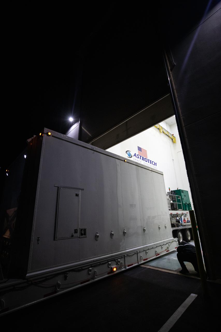 The transport carrier containing NASA’s Plankton, Aerosol, Cloud, ocean Ecosystem (PACE) observatory spacecraft is offloaded at the Astrotech Space Operations Facility near the agency’s Kennedy Space Center in Florida on Tuesday, Nov. 14, 2023. PACE was shipped from the agency’s Goddard Space Flight Center in Greenbelt, Maryland, and is targeted to launch on January 30, 2024, on a SpaceX Falcon 9 rocket lifting off from Space Launch Complex 40 at Cape Canaveral Space Force Station. The PACE observatory will help us better understand how the ocean and atmosphere exchange carbon dioxide, measure key atmospheric variables associated with air quality and Earth's climate, and monitor ocean health, in part by studying phytoplankton, tiny plants and algae that sustain the marine food web. 