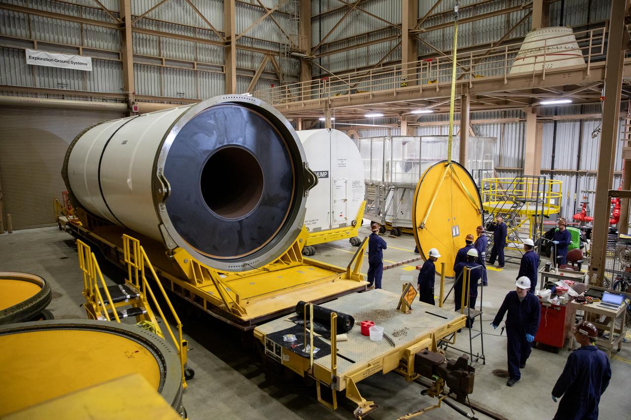 Engineers and technicians process and inspect the propellant of the right forward center segment of the Space Launch System solid rocket boosters for the Artemis II mission inside the Rotation, Processing and Surge Facility (RPSF) at NASA’s Kennedy Space Center in Florida on Monday, Nov. 27, 2023. Since arriving via rail in September, the team has been examining each segment one-by-one to make sure they are ready for integration and launch before being moved to the Vehicle Assembly Building for stacking atop the mobile launcher. Artemis II astronauts Reid Wiseman, Victor Glover, Christina Koch, and Jeremy Hansen will blast off from Kennedy and travel around the moon for the agency’s first crewed mission under Artemis that will test all of the Orion spacecraft’s systems.