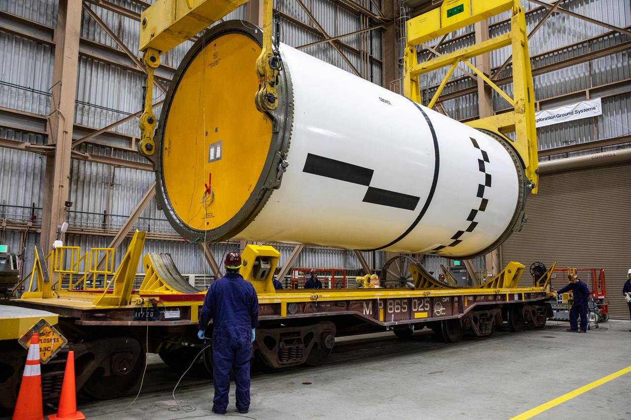 Engineers and technicians process the right forward center segment of the Space Launch System solid rocket boosters for the Artemis II mission inside the Rotation, Processing and Surge Facility (RPSF) at NASA’s Kennedy Space Center in Florida on Tuesday, Nov. 27, 2023.   The team has been examining the 10 booster segments one-by-one then lifting them to make sure they are ready for integration and launch before moving them to the Vehicle Assembly Building for stacking atop the mobile launcher. Artemis II astronauts Reid Wiseman, Victor Glover, Christina Koch, and Jeremy Hansen will blast off from Kennedy and travel around the moon for the agency’s first crewed mission under Artemis that will test all of the Orion spacecraft’s systems.