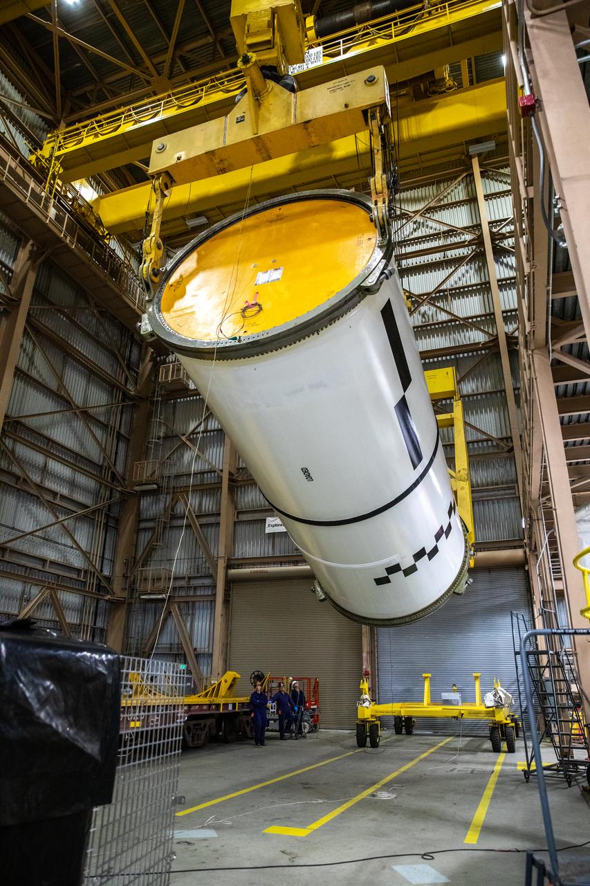Engineers and technicians process the right forward center segment of the Space Launch System solid rocket boosters for the Artemis II mission inside the Rotation, Processing and Surge Facility (RPSF) at NASA’s Kennedy Space Center in Florida on Tuesday, Nov. 27, 2023.   The team has been examining the 10 booster segments one-by-one then lifting them to make sure they are ready for integration and launch before moving them to the Vehicle Assembly Building for stacking atop the mobile launcher. Artemis II astronauts Reid Wiseman, Victor Glover, Christina Koch, and Jeremy Hansen will blast off from Kennedy and travel around the moon for the agency’s first crewed mission under Artemis that will test all of the Orion spacecraft’s systems.